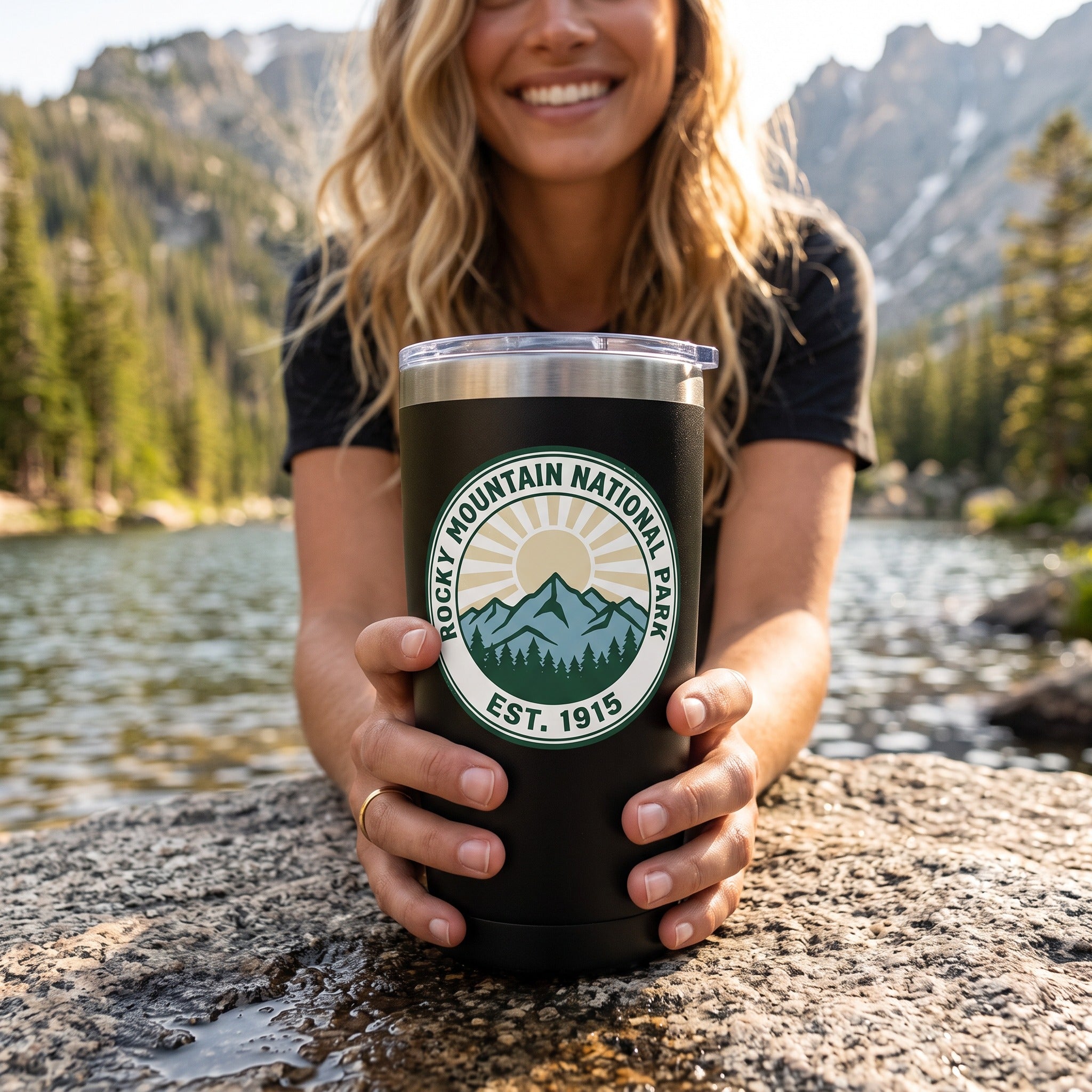 Rocky Mountain National Park 20oz insulated tumbler in black, held by an approved model, close lifestyle photograph