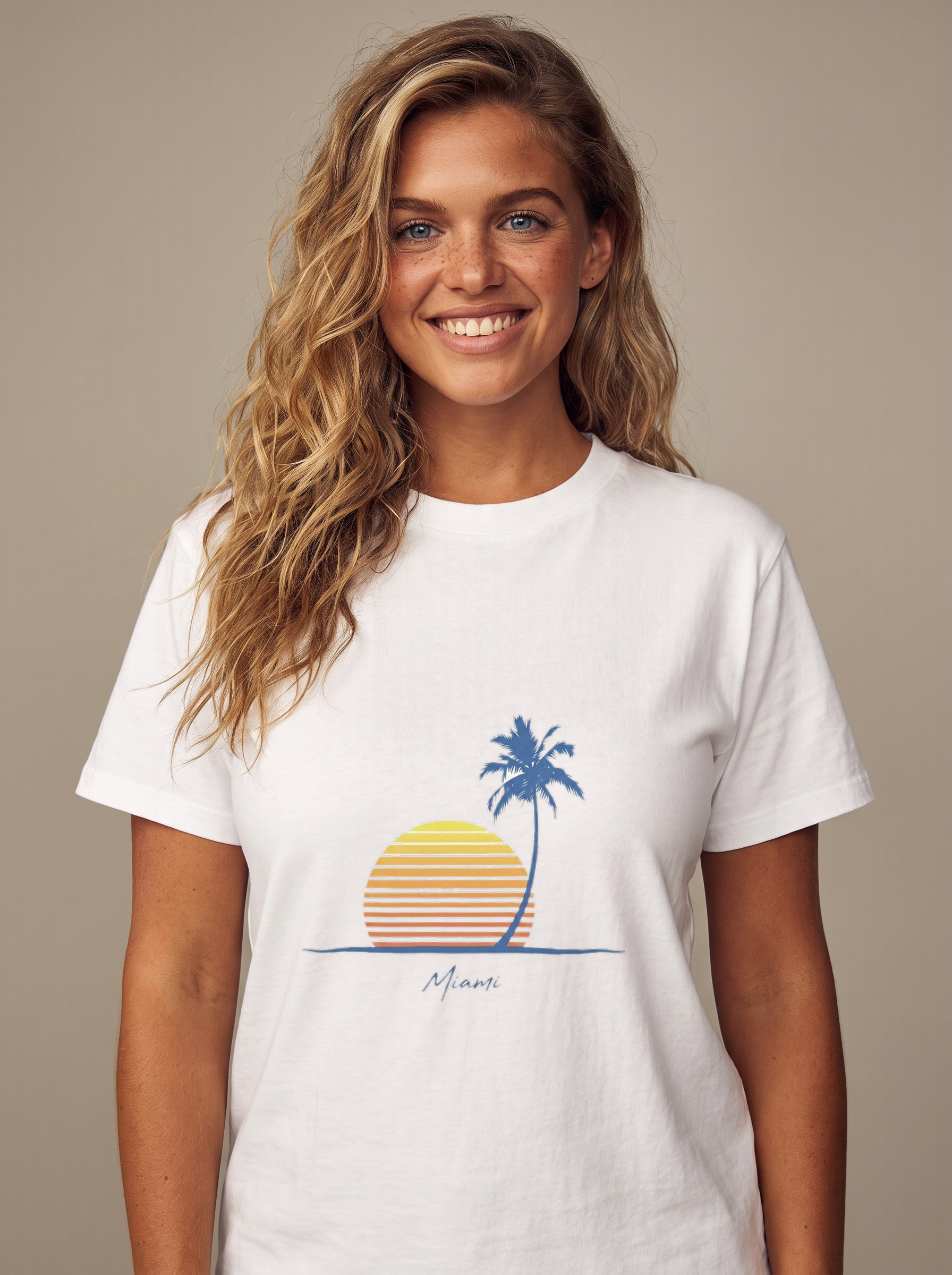 Woman wearing the Retro Palm and Sunset minimalist tee in White, single palm over a striped sunset with Miami script centered on the chest
