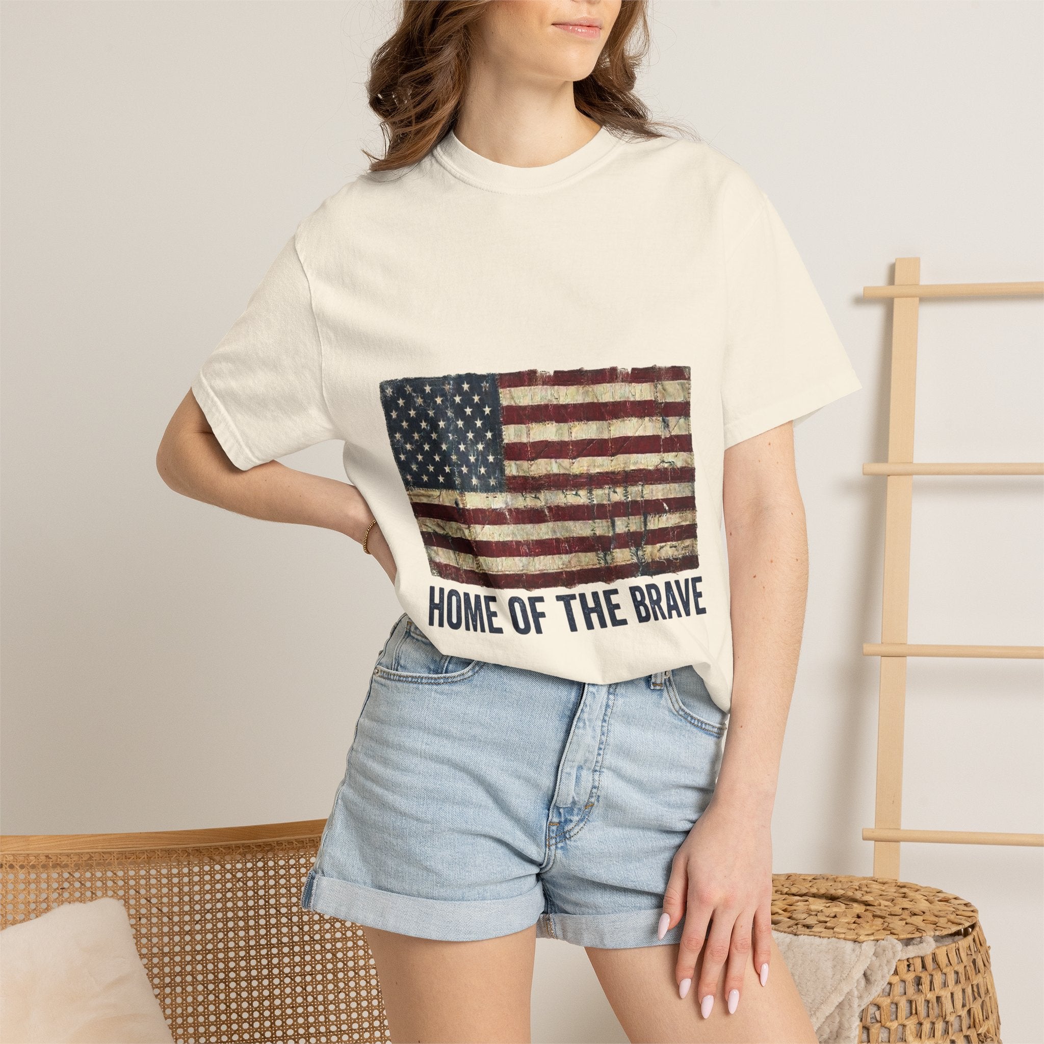 Distressed tattered US flag with HOME OF THE BRAVE lettering on a garment-dyed Comfort Colors vintage tee