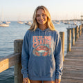 Feeling Crabby Hoodie in blue jean, worn by an approved model, wide lifestyle photograph