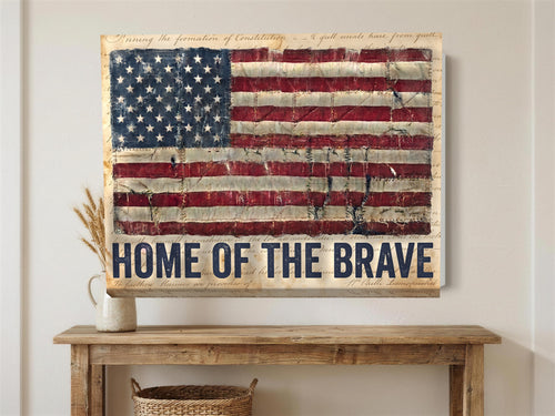 American flag Home of the Brave canvas wall art hanging above a rustic console table