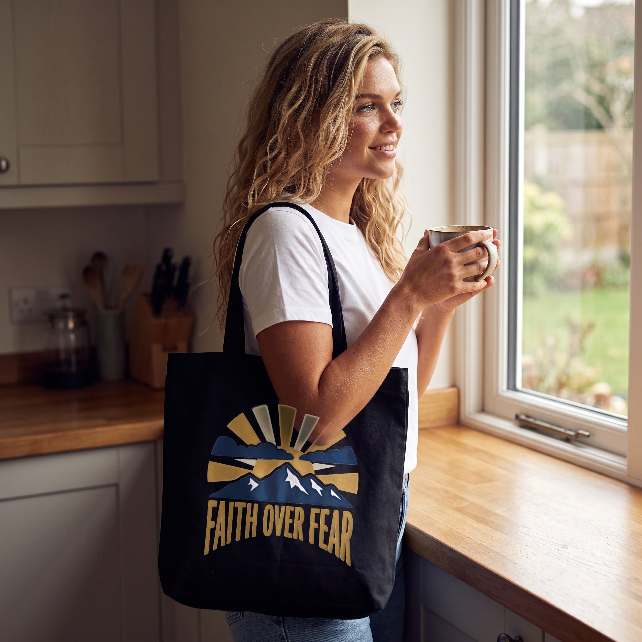 Faith Over Fear canvas tote bag in black, carried by an approved model, wide lifestyle photograph