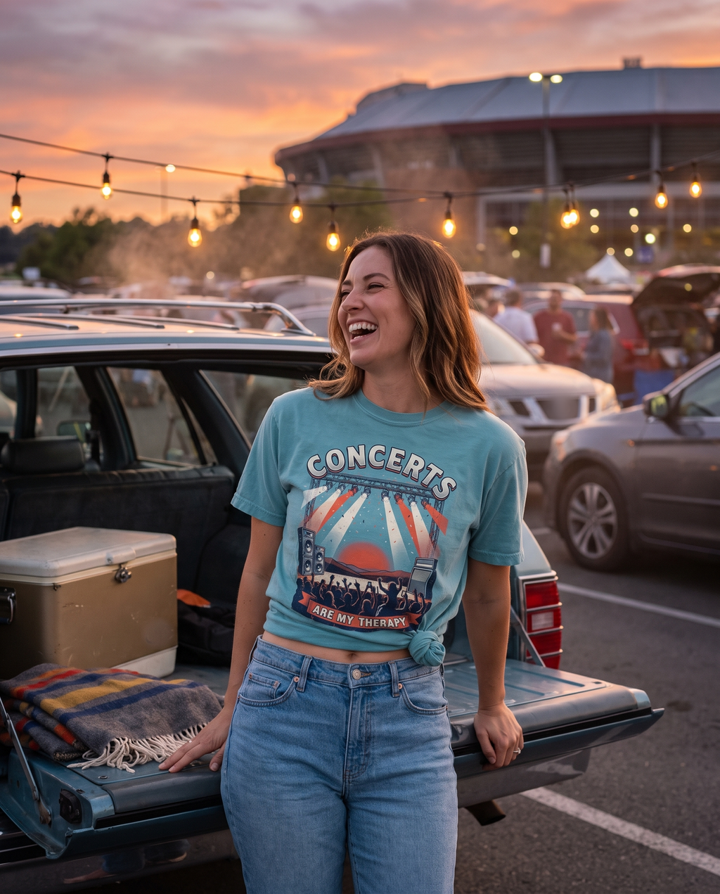 Bay Comfort Colors Concerts Are My Therapy tee with a side knot, worn at a tailgate under string lights before a show. AI generated model imagery, no real person photographed.