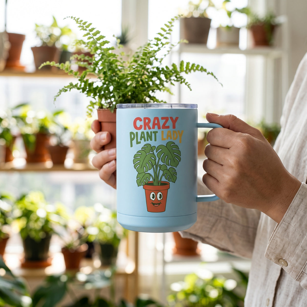 Crazy Plant Lady 15oz insulated mug in light blue, held by an approved model, close lifestyle photograph