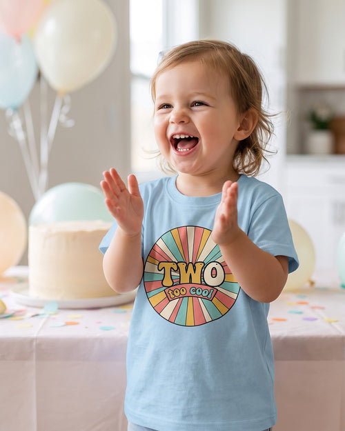 Two Too Cool 2nd birthday retro sunburst design on a toddler tee, two year old laughing at her birthday party