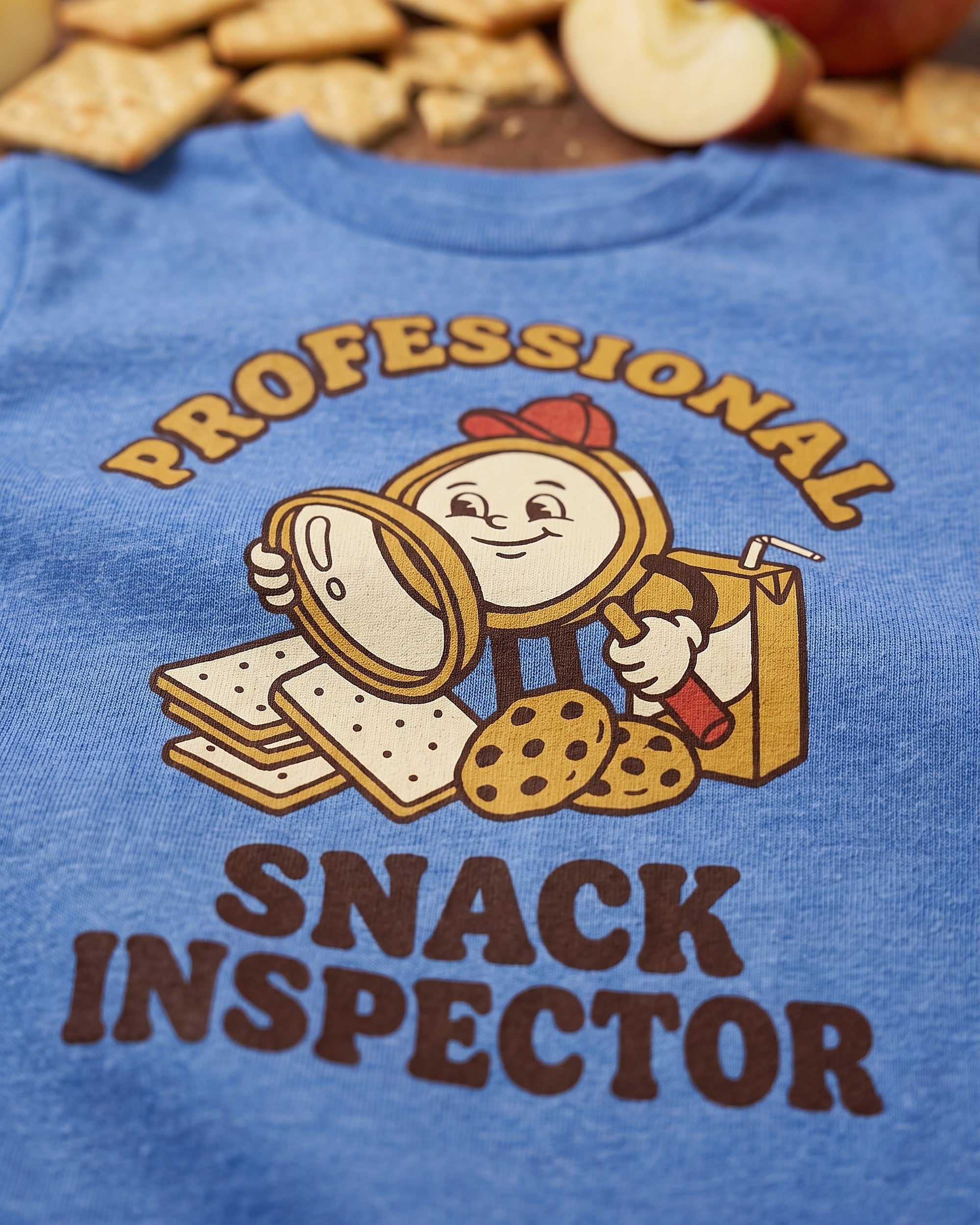 Close up of the Professional Snack Inspector retro mascot print showing soft matte ink on cotton weave