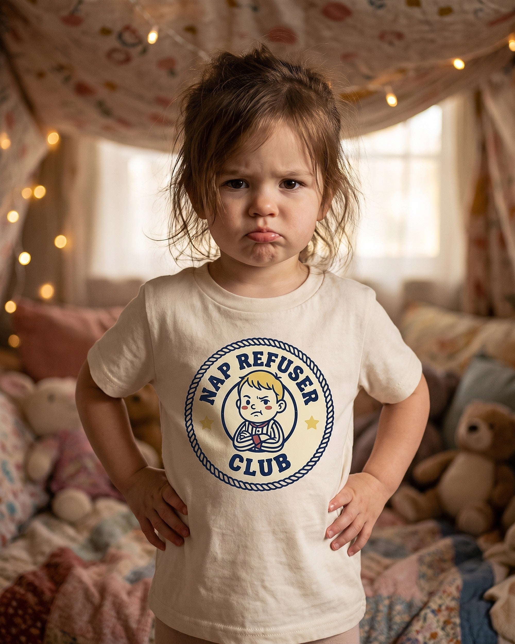 Nap Refuser Club badge design on a kids tee, child laughing in a playful scene