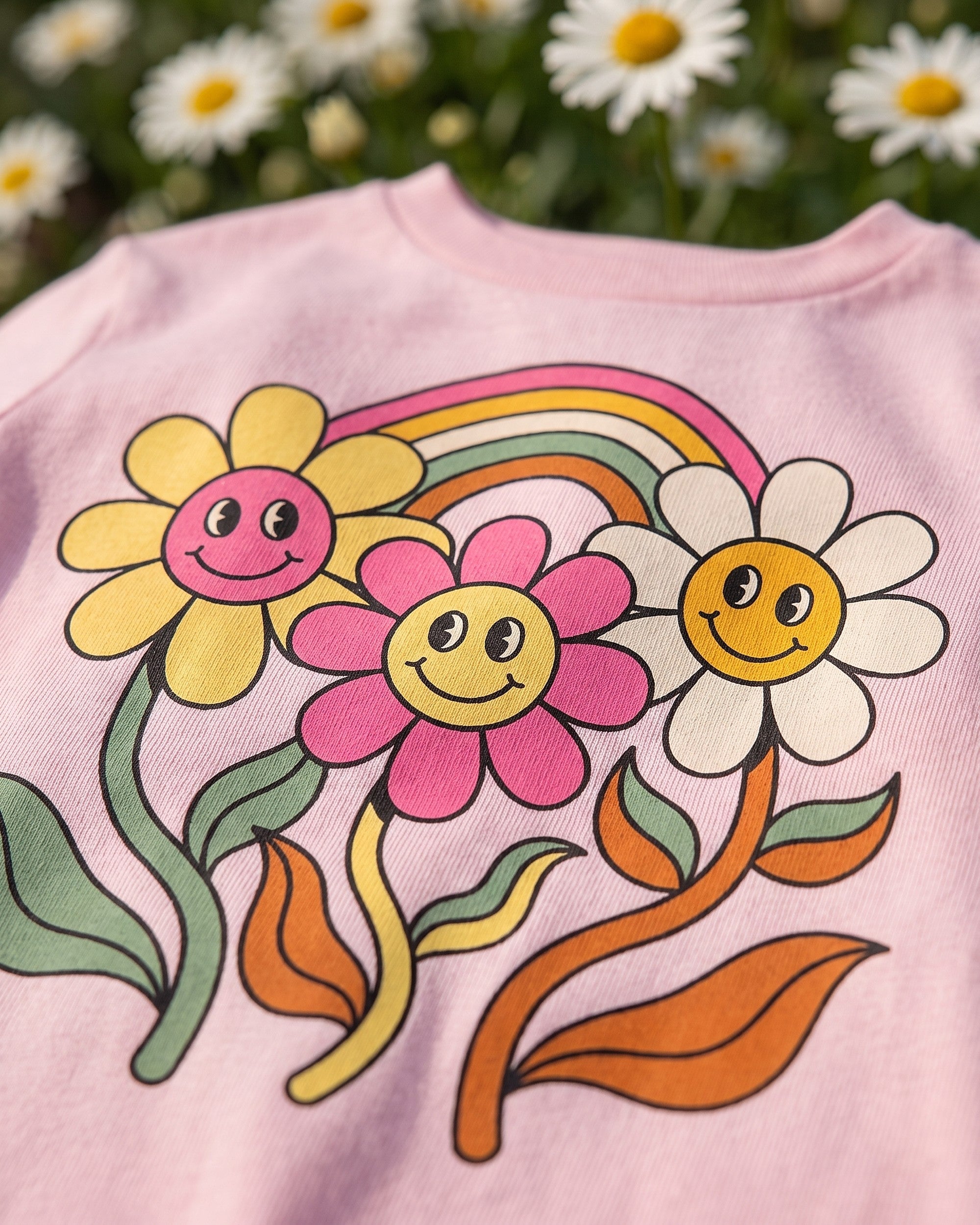 Close up of the groovy daisies rainbow print showing soft matte ink on cotton weave