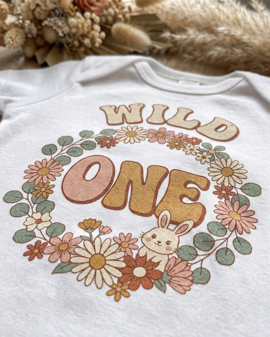 Close up of the Wild One boho floral bunny first birthday print showing soft matte ink on cotton weave