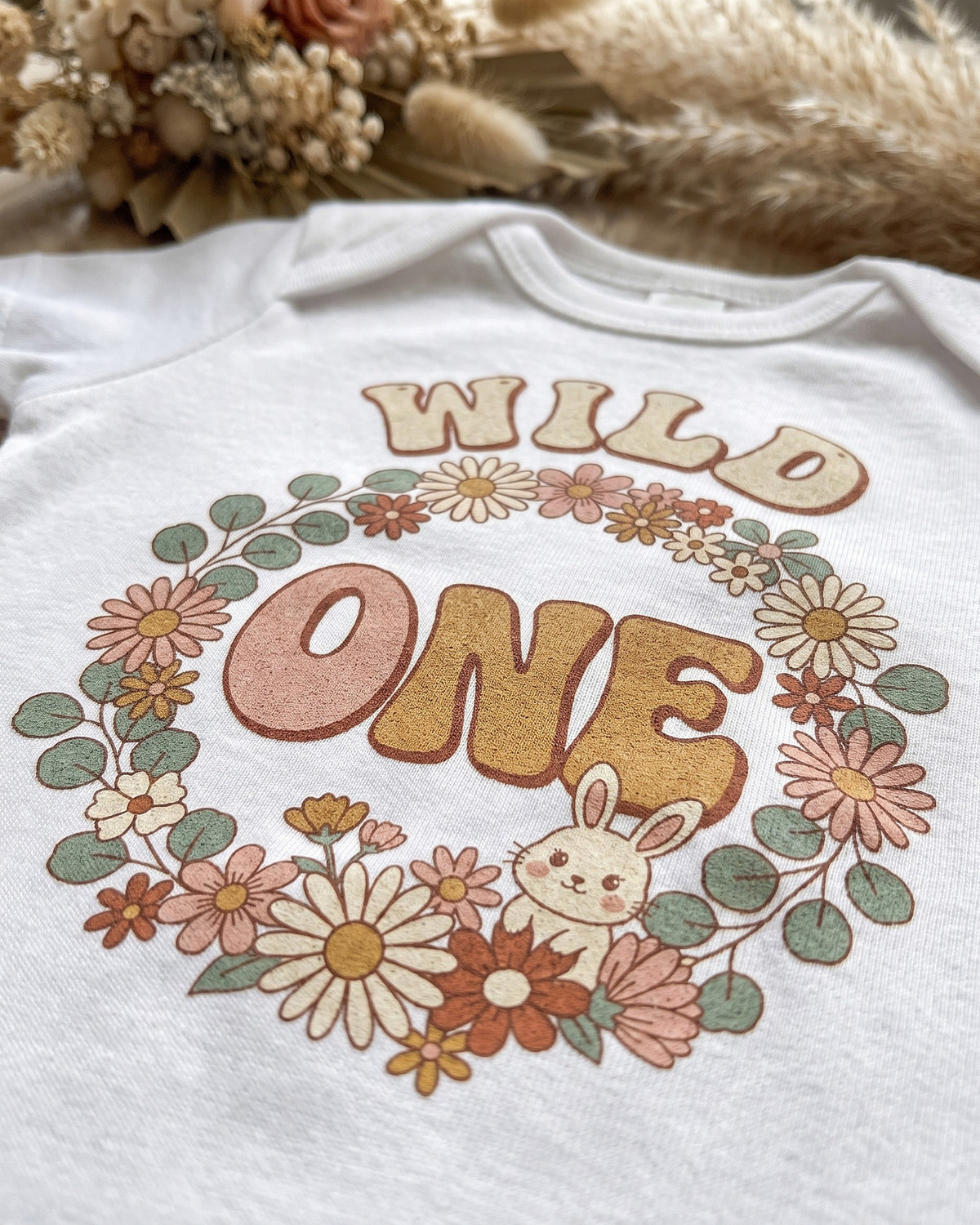 Close up of the Wild One boho floral bunny first birthday print showing soft matte ink on cotton weave