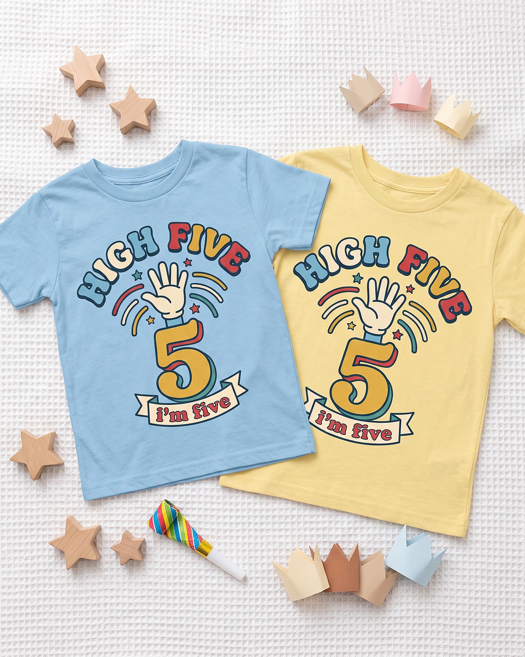 Flat lay of the High Five 5th birthday design across matching kids garments with playful props