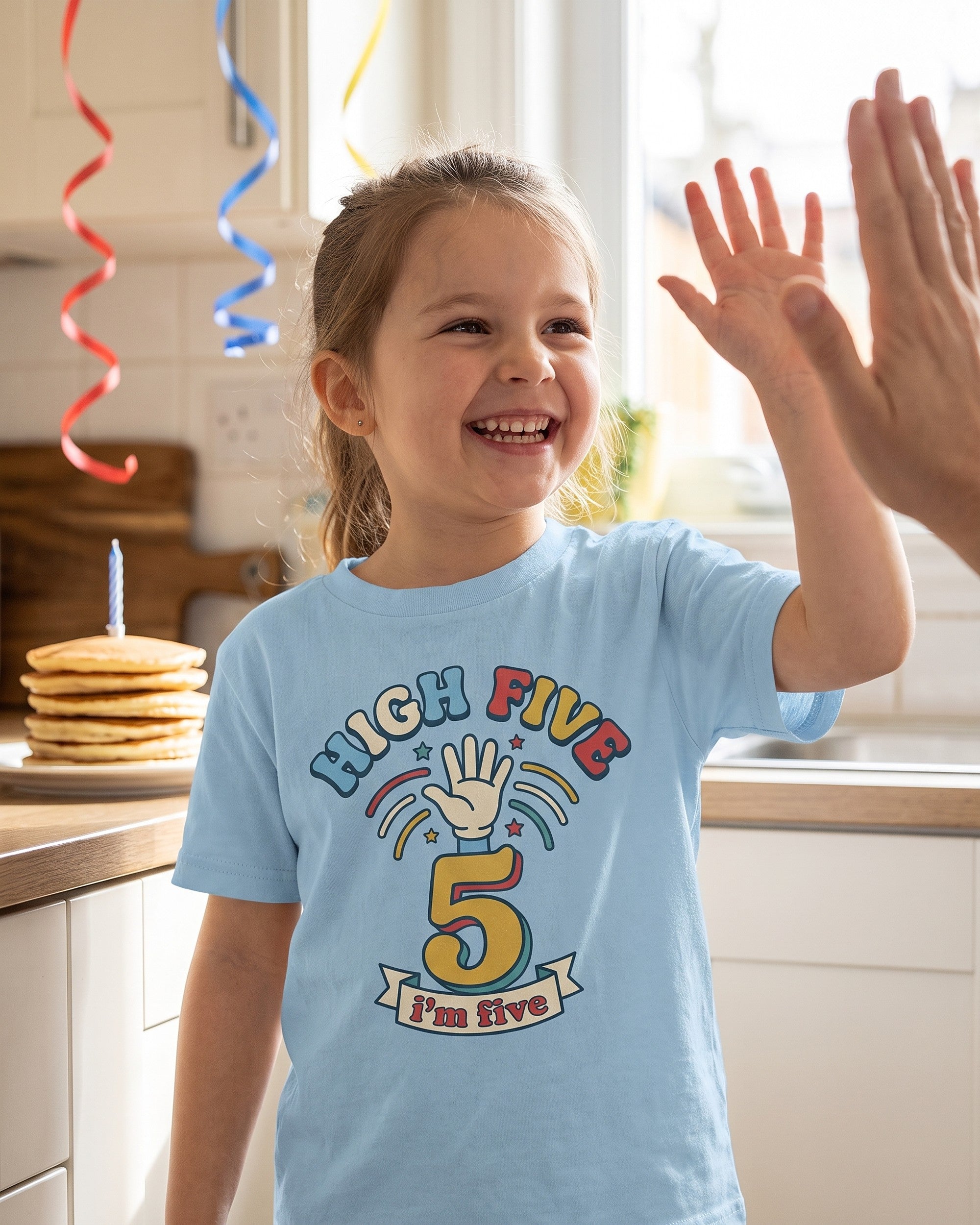 High Five 5th birthday design on a kids tee, child laughing in a playful scene