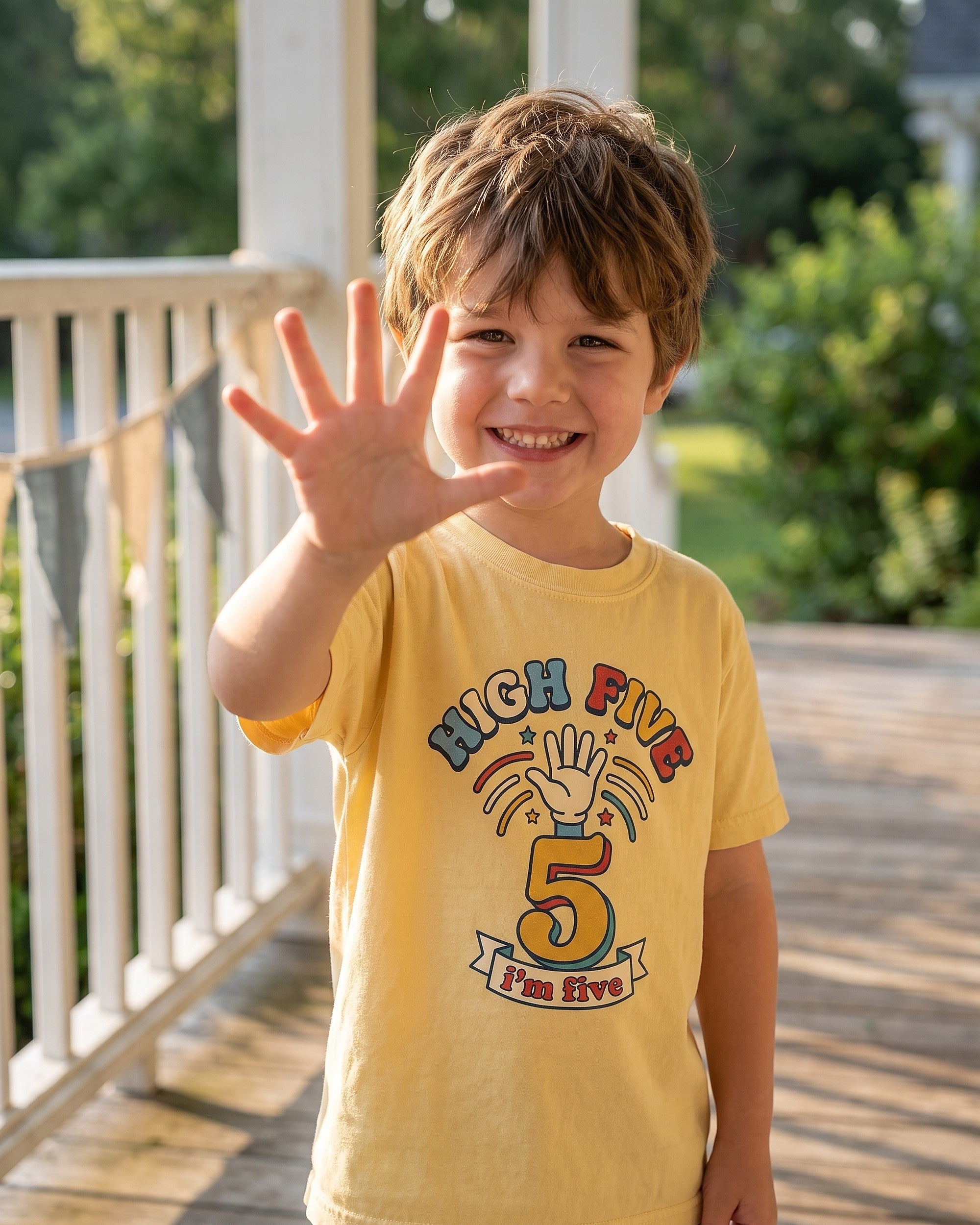 High Five 5th birthday design worn by a smiling child outdoors