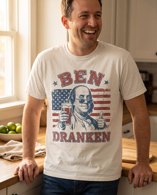 Ben Dranken tee close crop in natural ivory, the full print legible in kitchen window light