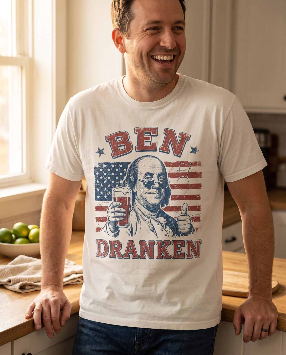 Ben Dranken tee close crop in natural ivory, the full print legible in kitchen window light