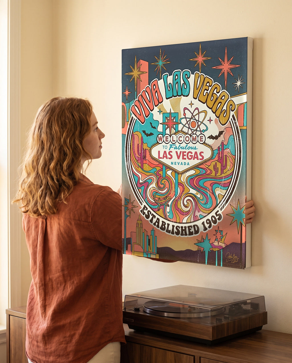 Woman leveling the Viva Las Vegas canvas, showing its true 18 by 24 inch size