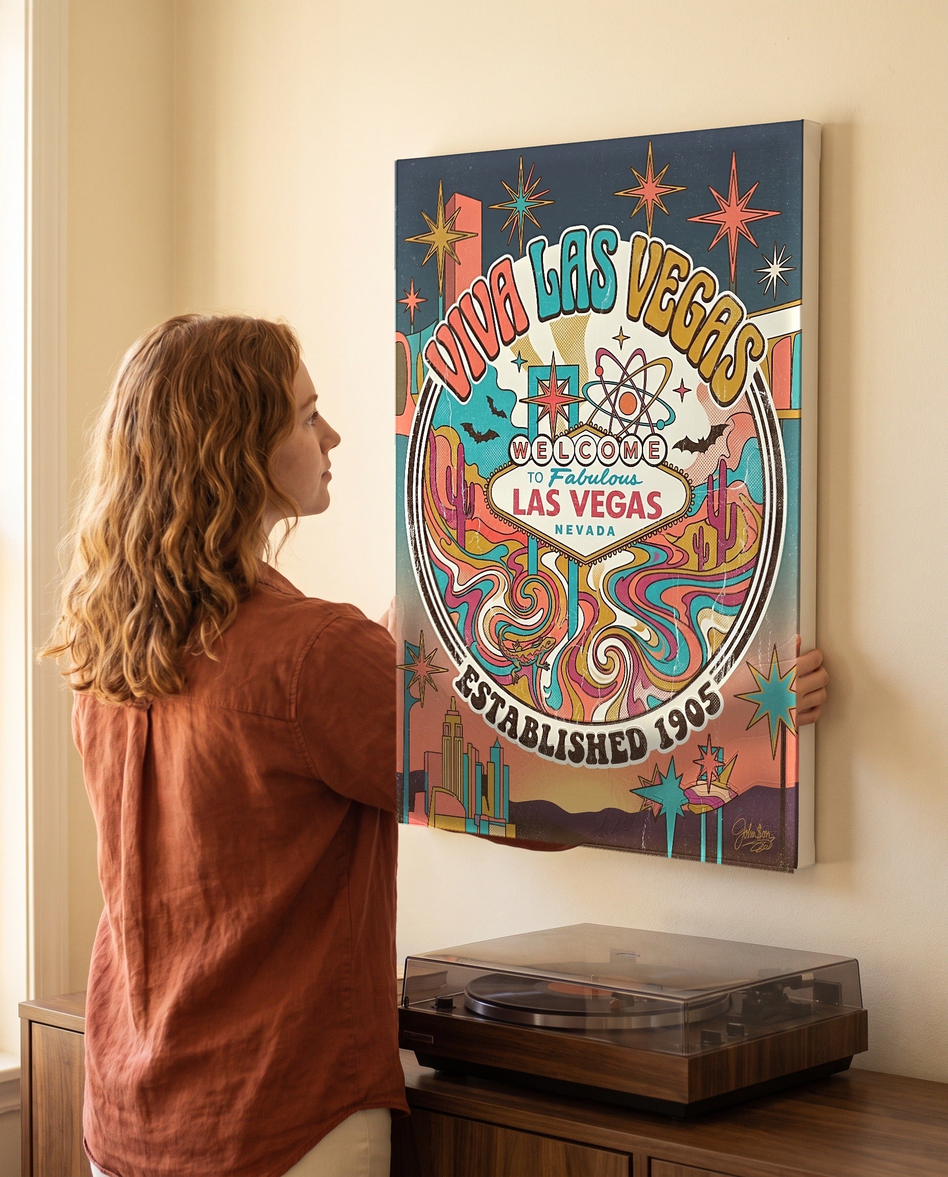 Woman leveling the Viva Las Vegas canvas, showing its true 18 by 24 inch size
