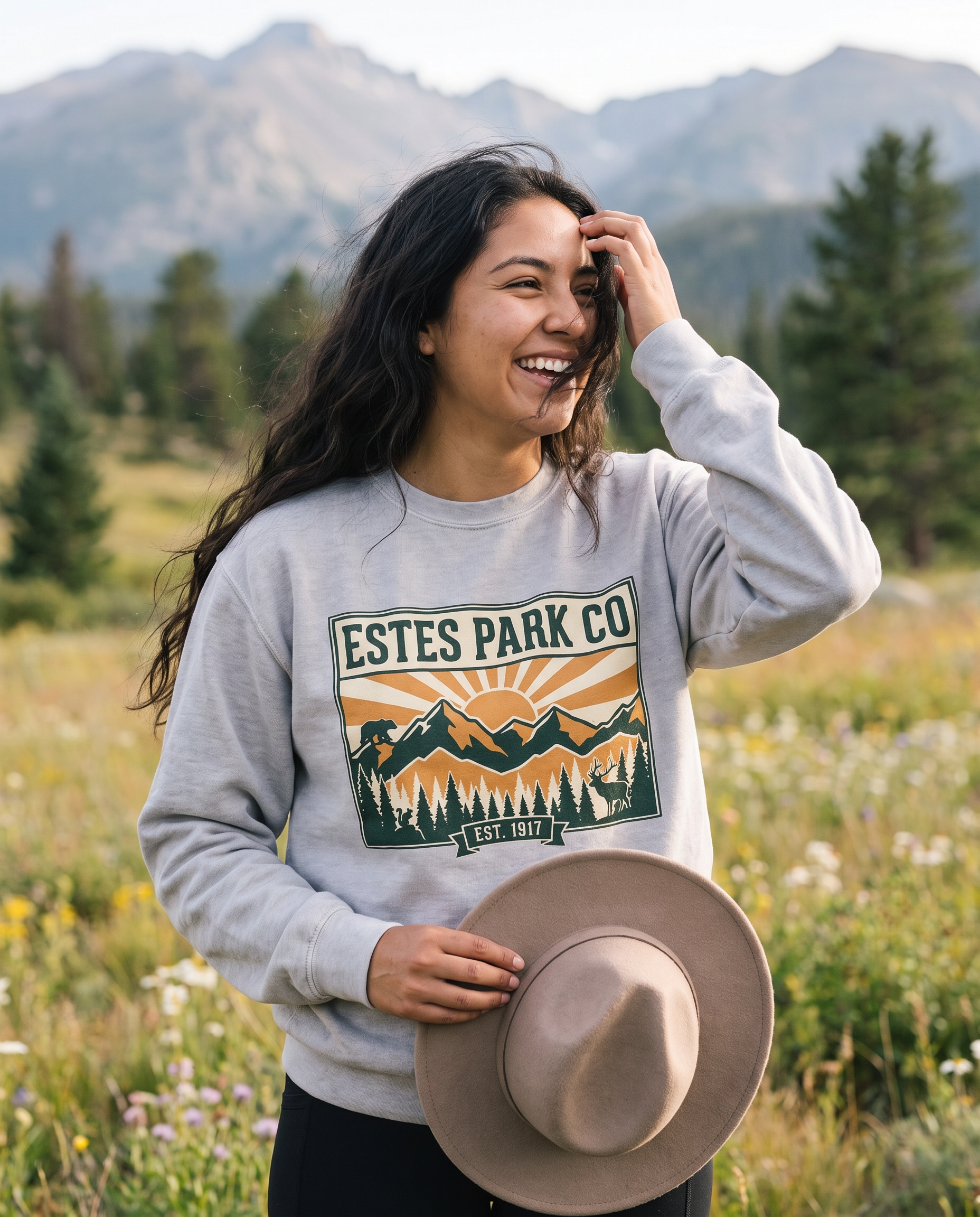 Smoke grey Estes Park CO hidden wildlife crewneck sweatshirt on a woman in a Rocky Mountain wildflower meadow