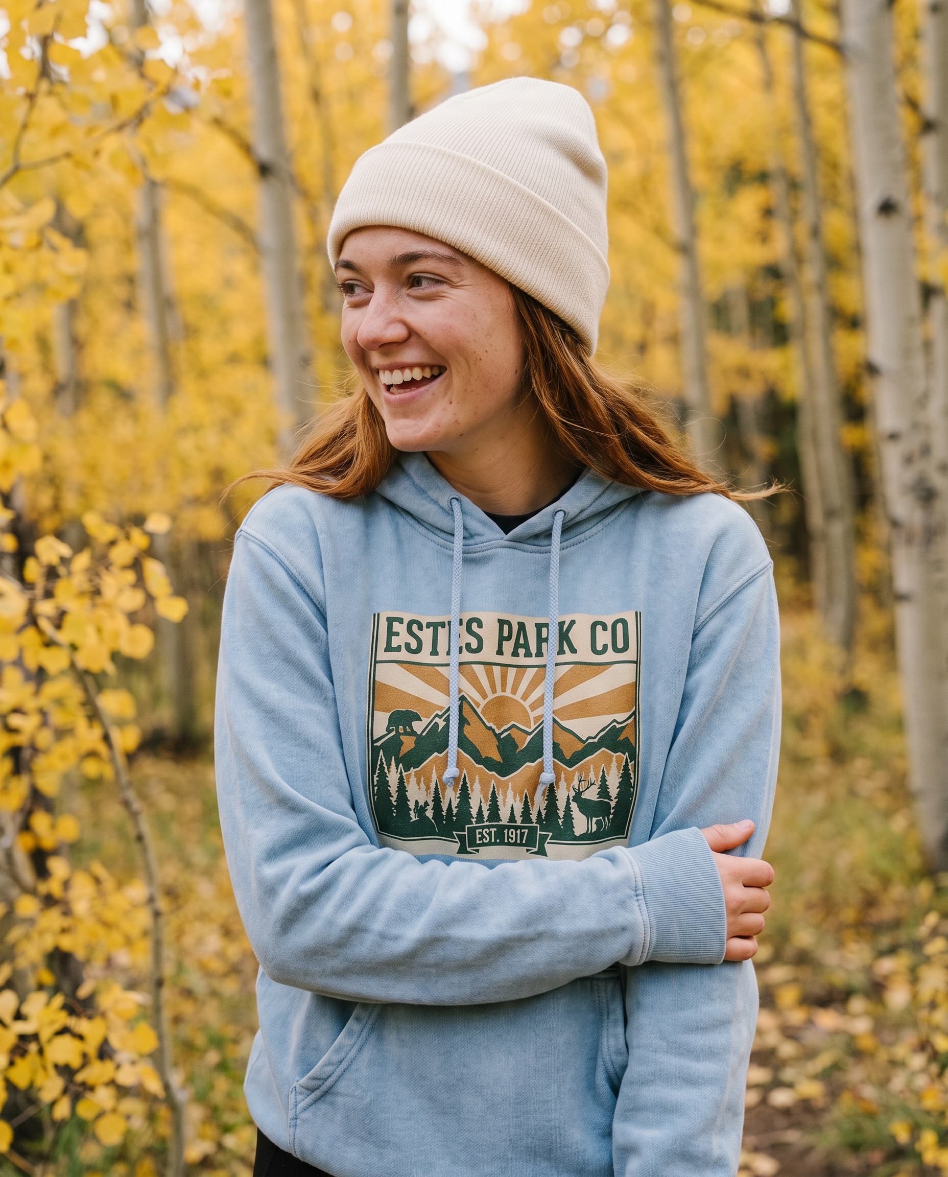 Blue Jean Estes Park CO hidden wildlife hoodie on a woman in a golden aspen grove near Estes Park Colorado