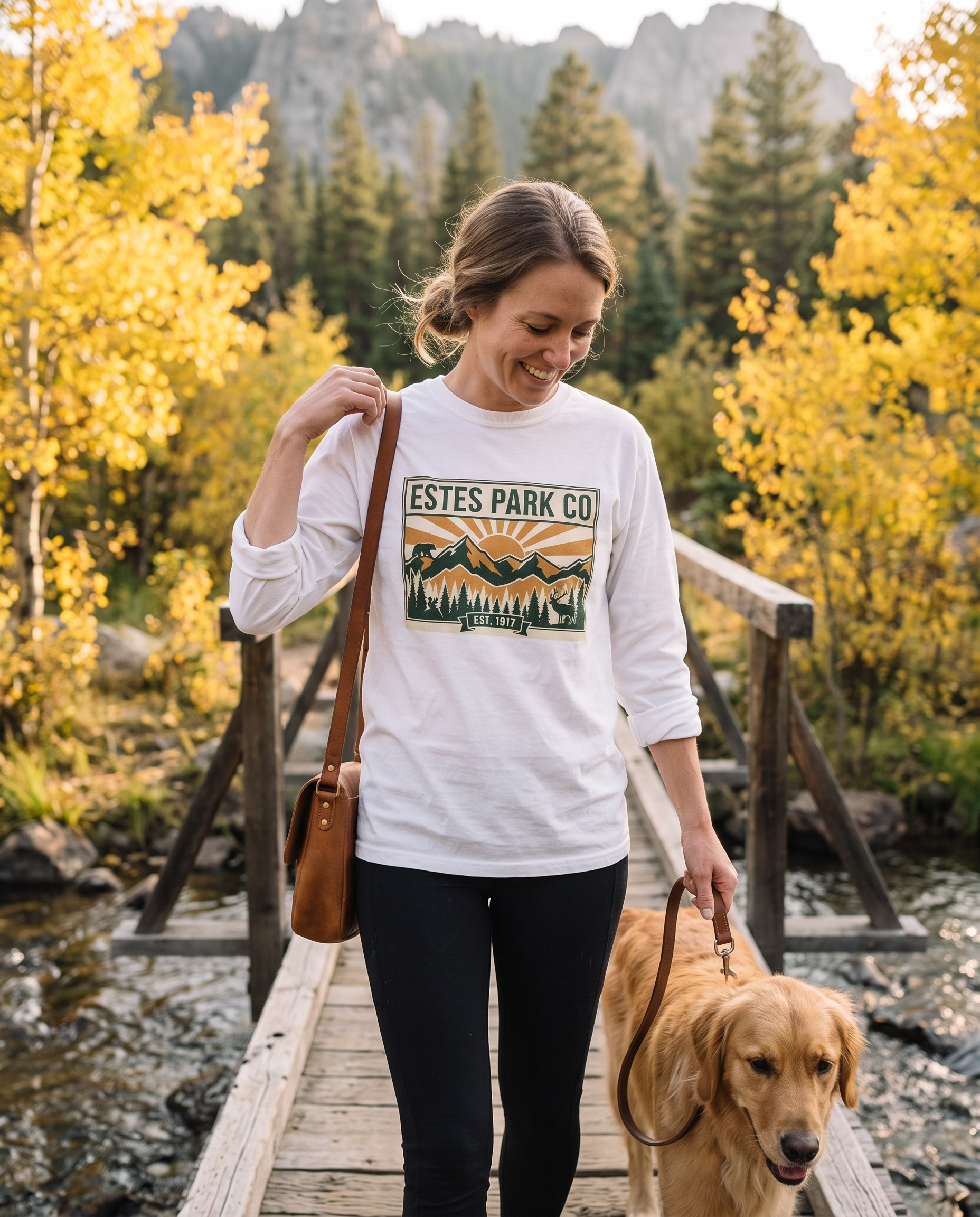 Woman walking her dog across a mountain footbridge near Estes Park Colorado in the white Estes Park CO hidden wildlife long sleeve tee