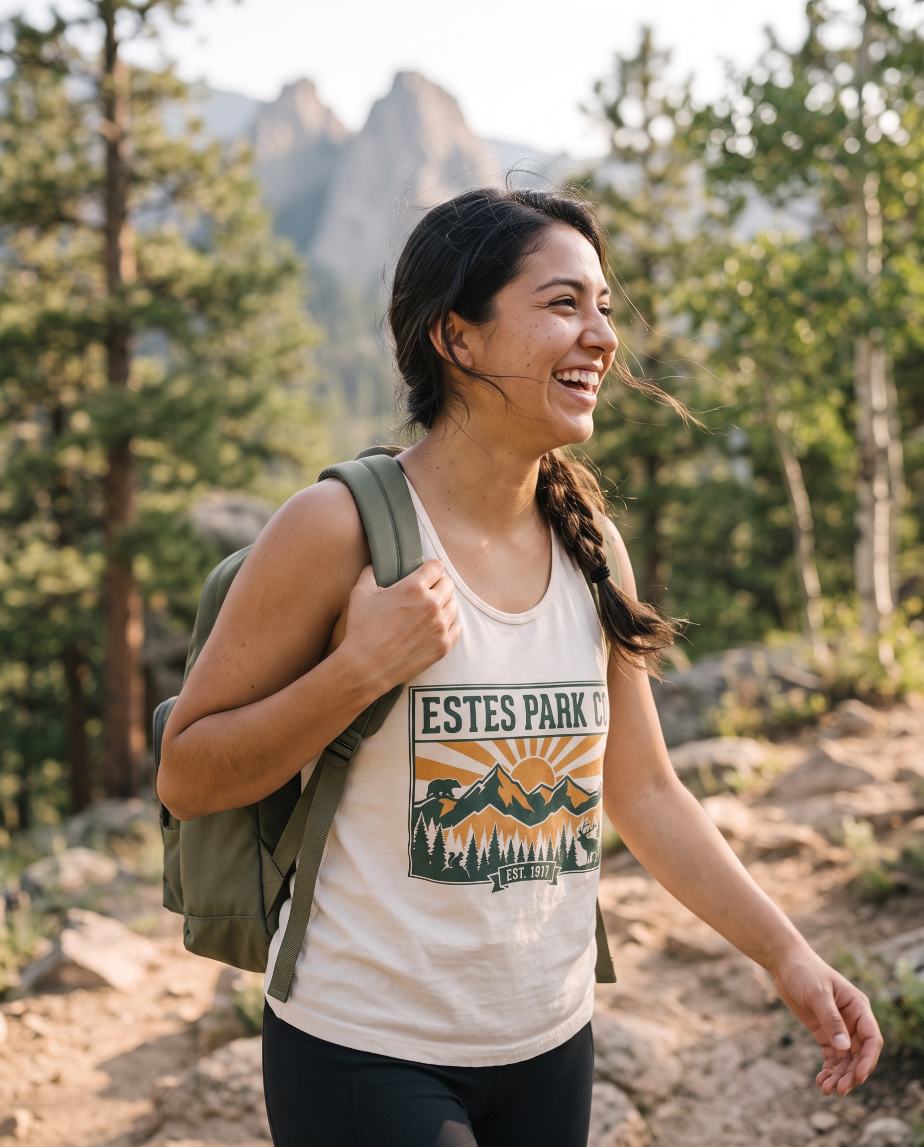 Woman hiking a Rocky Mountain trail near Estes Park Colorado wearing the ivory Estes Park CO hidden wildlife tank top