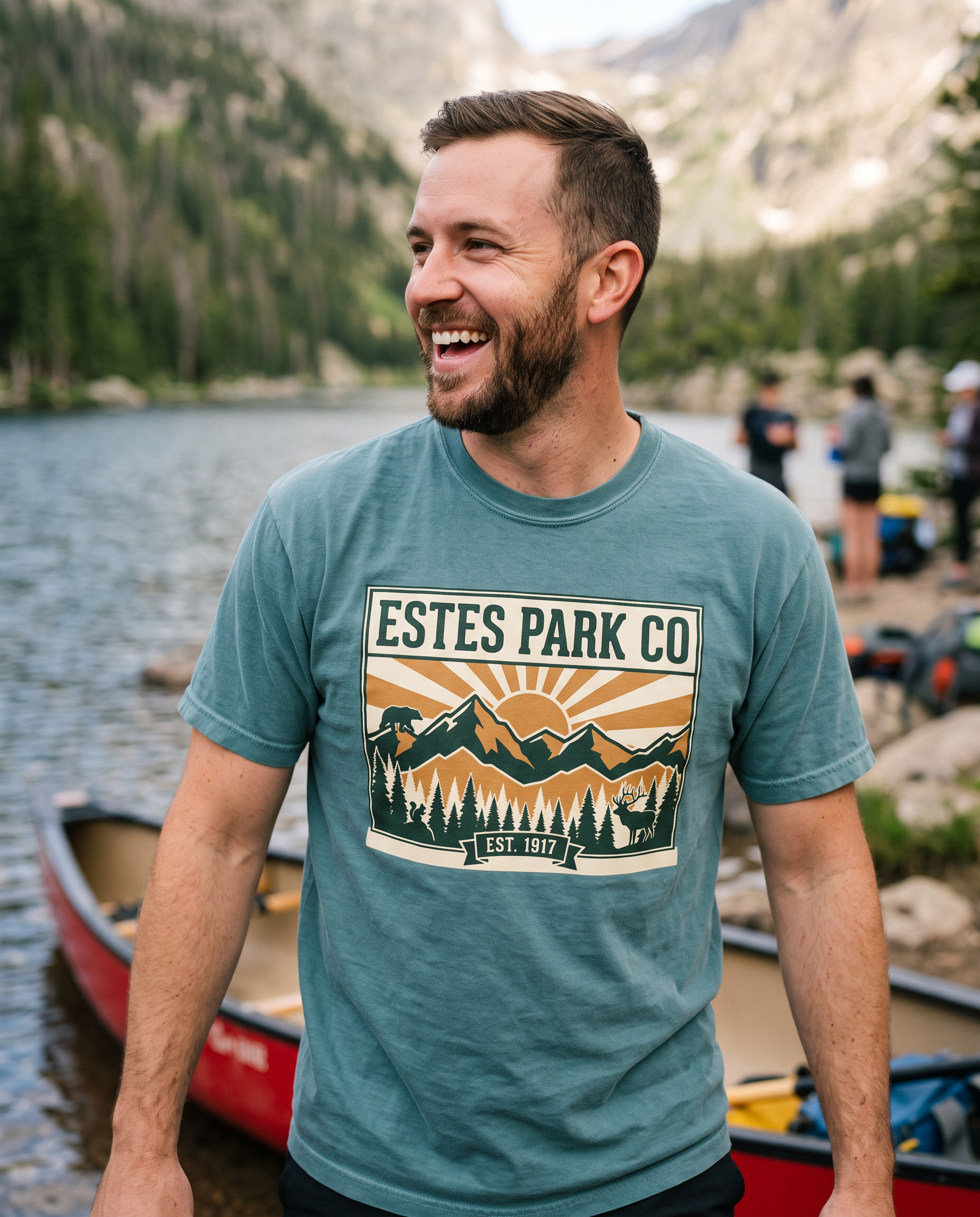 Bay Estes Park CO hidden wildlife tee on a man loading a canoe at an alpine lake