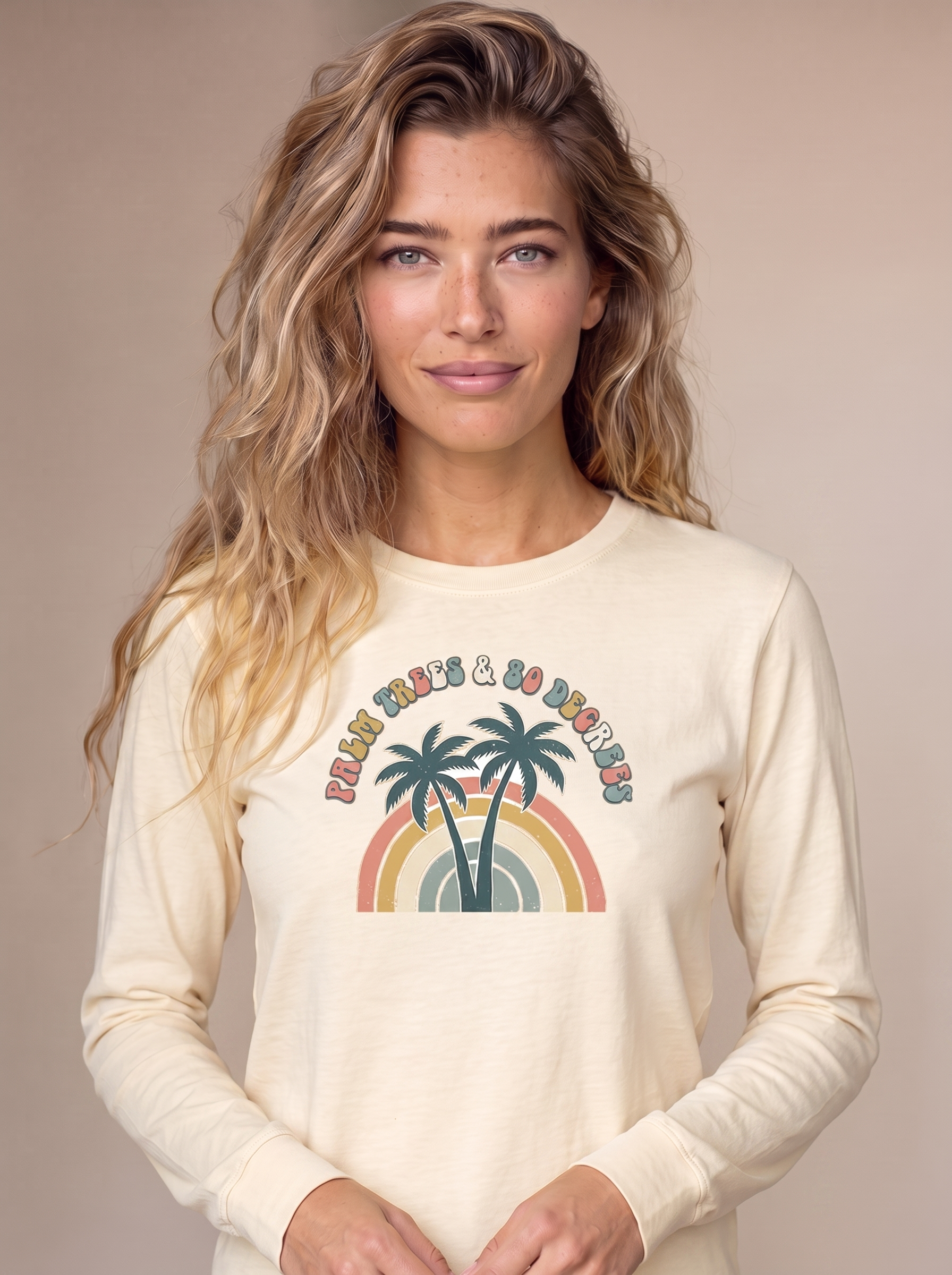 Palm Trees and 80 Degrees long sleeve tee in Ivory cream on a model, twin palms and 70s rainbow with text centered on the chest