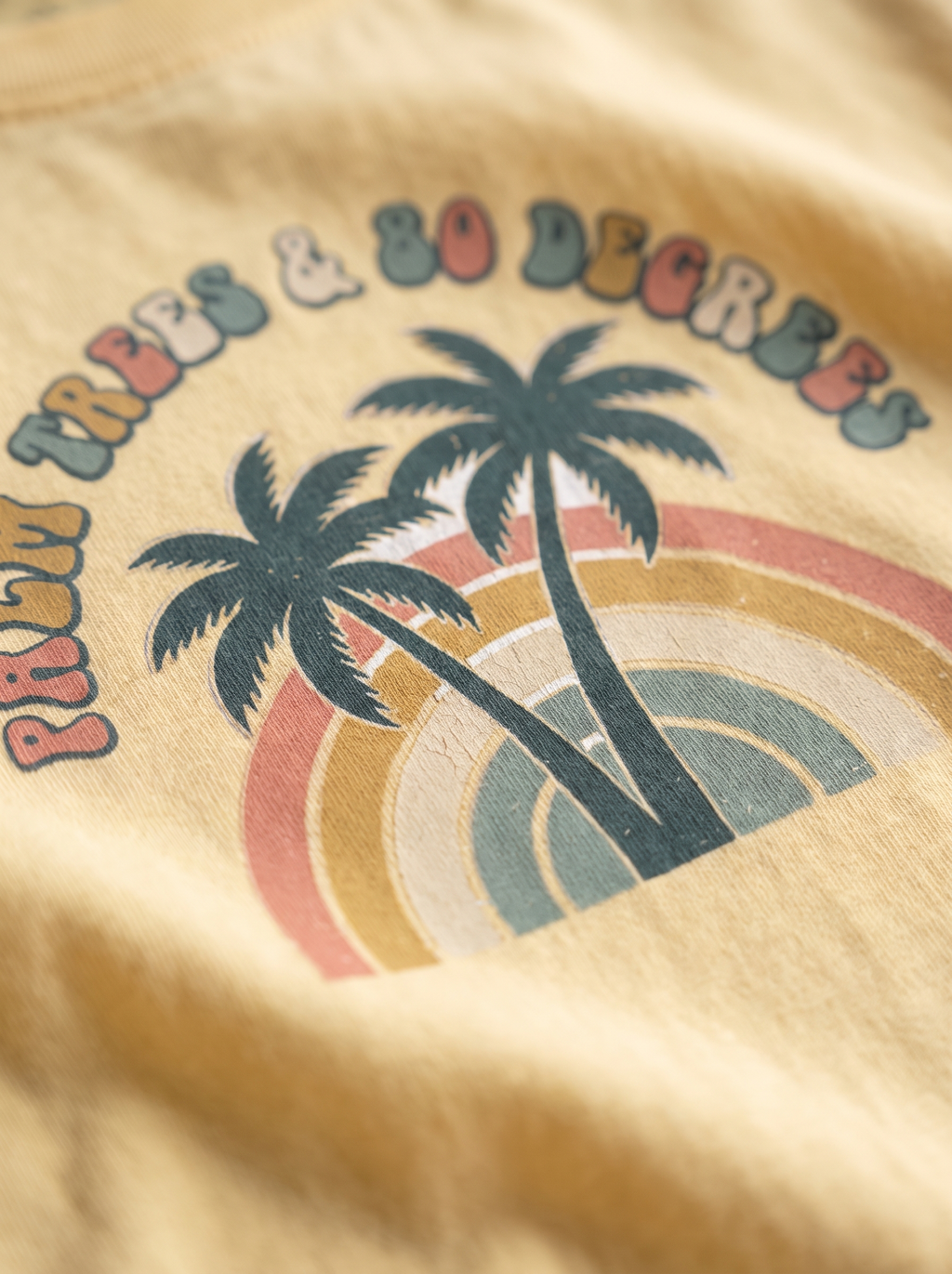 Close up of the Palm Trees and 80 Degrees long sleeve screen print, twin palms rainbow arch and bubble lettering in the cotton weave