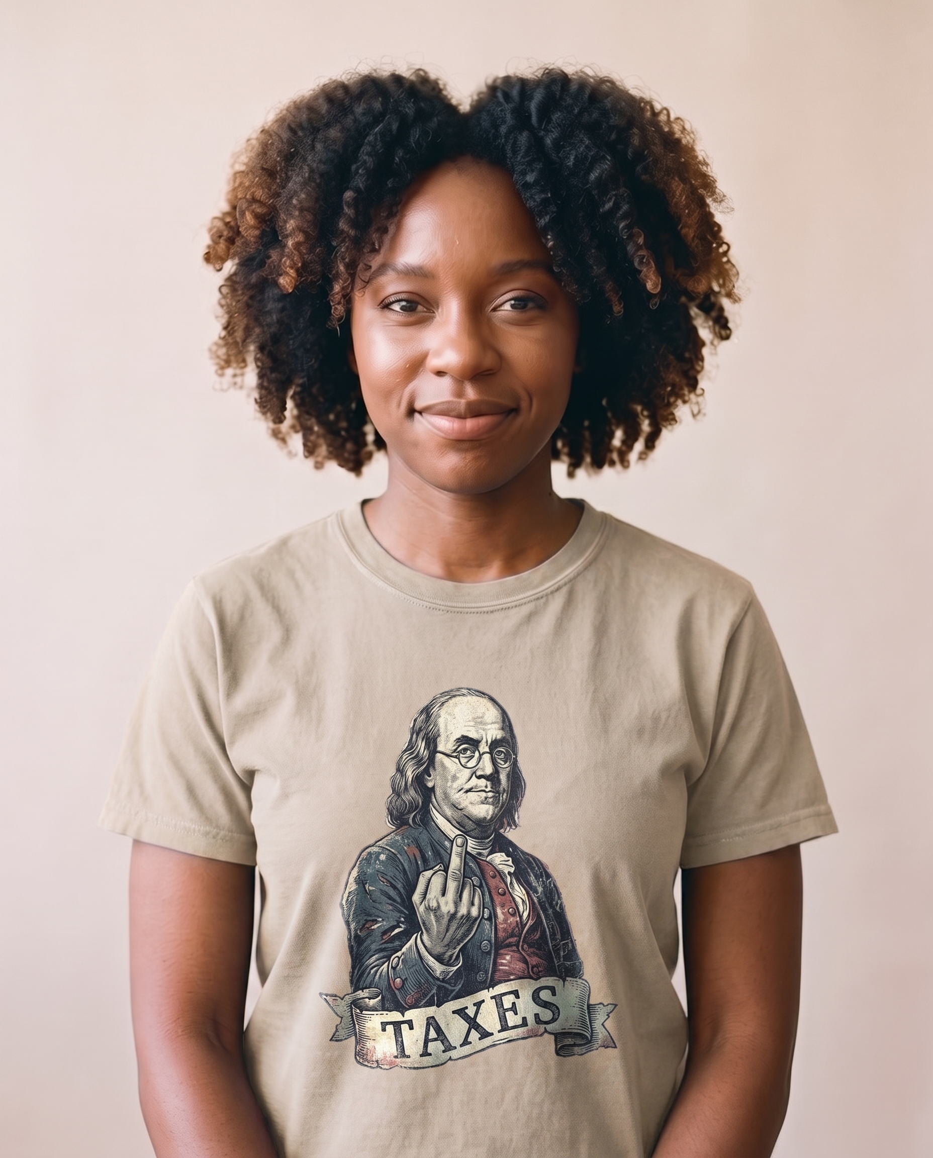 Woman wearing the Ben Franklin TAXES tee in Sand, vintage engraved Franklin print centered at mid-chest, matte screen print