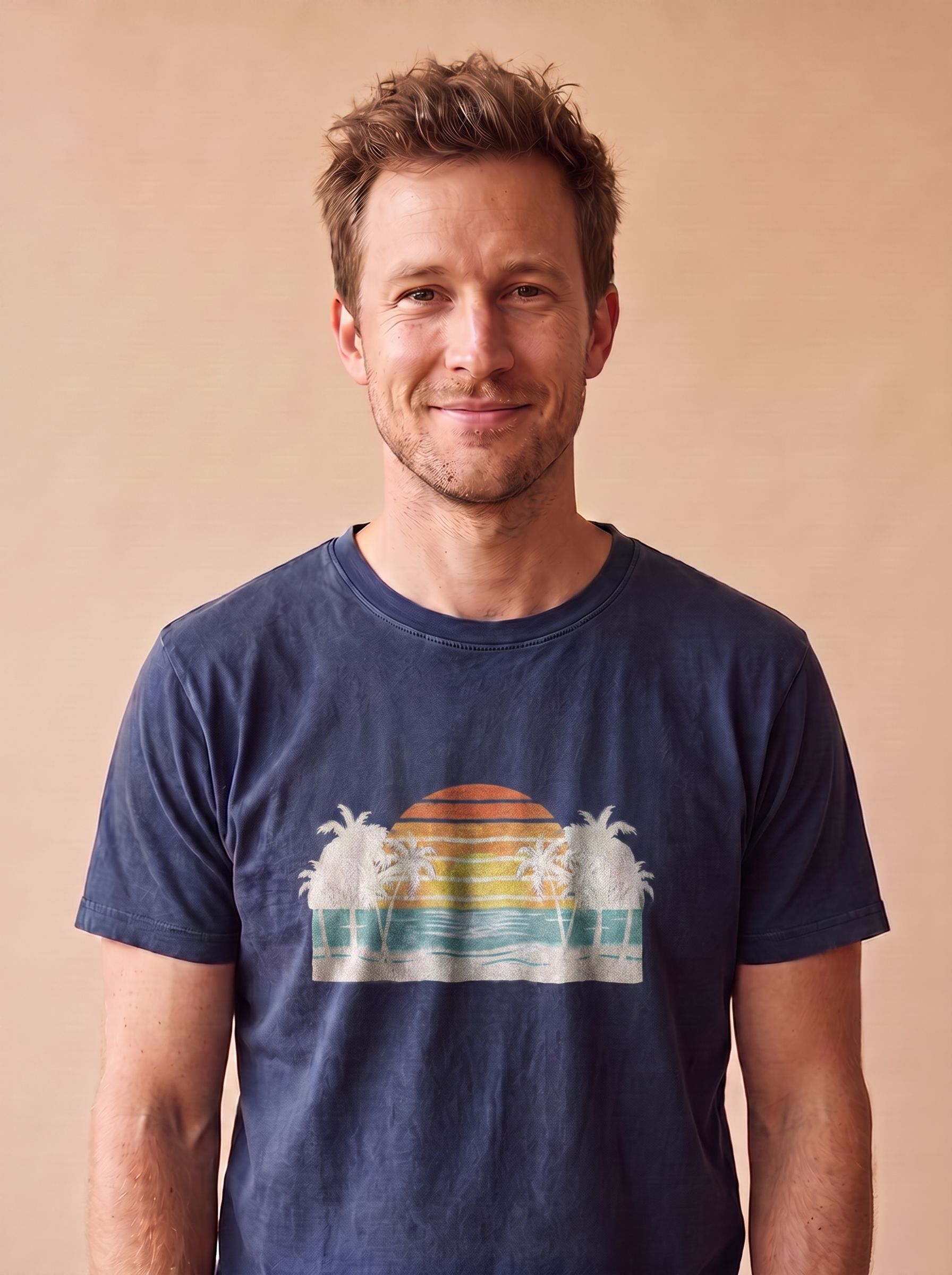 Man wearing the Retro Beach Sunset tee in True Navy, vintage sunset with palms and ocean waves screen printed centered at mid-chest, matte print conforming to the fabric