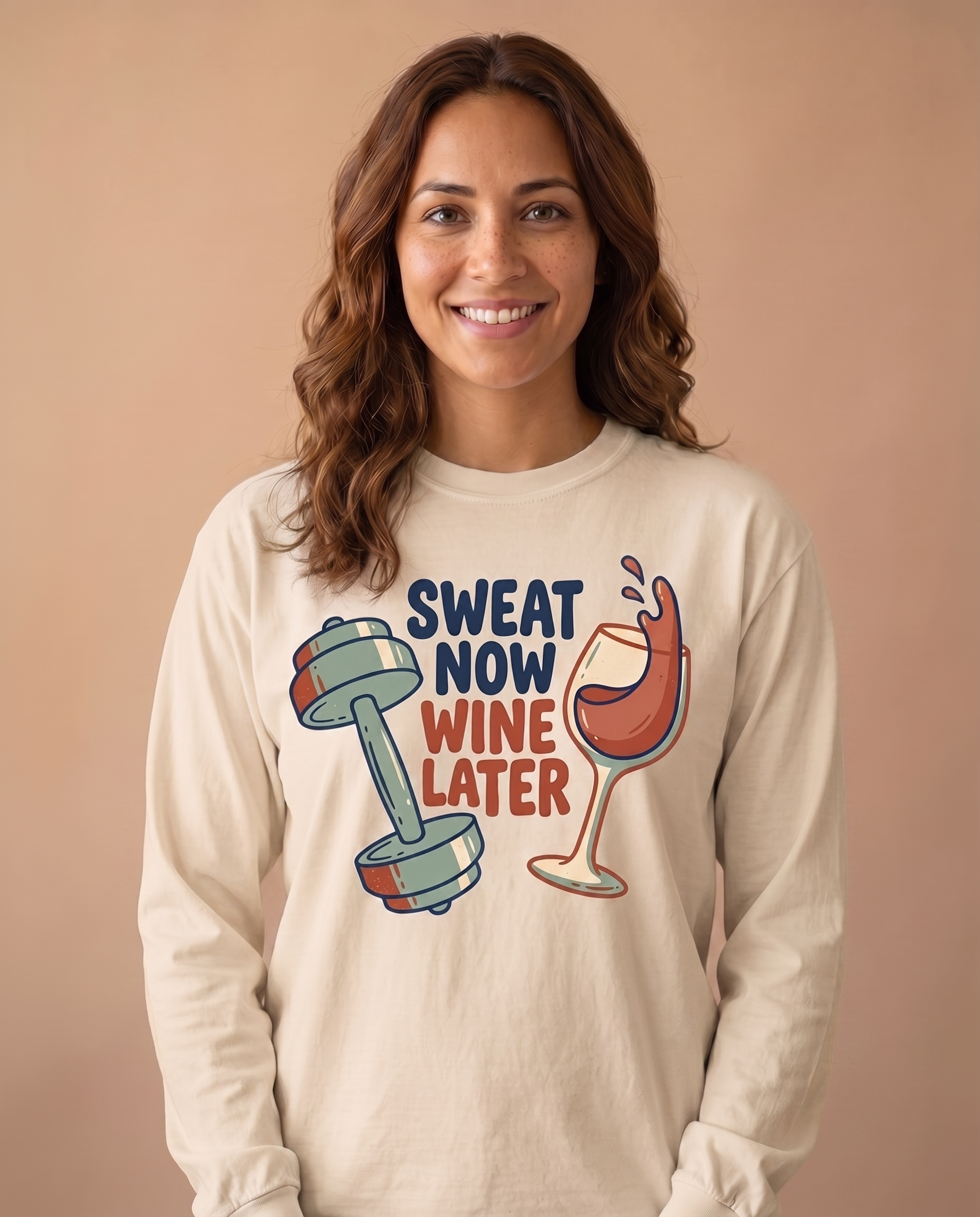 Sweat Now Wine Later long sleeve in Sandstone, stacked navy and rust lettering with dumbbell and wine glass print at mid chest