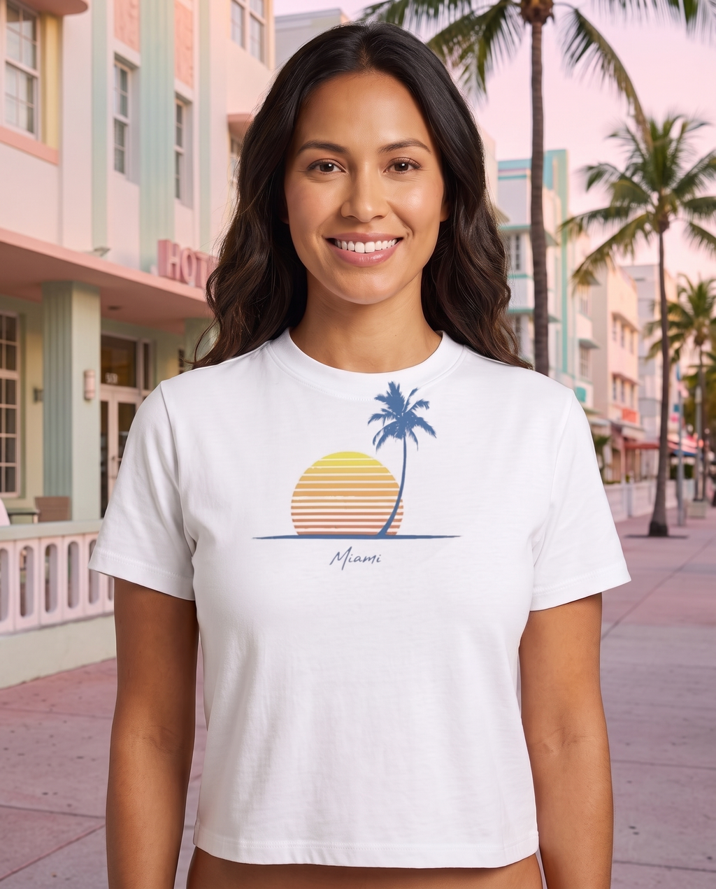Woman on Ocean Drive at dawn in the Retro Miami Palm Sunset tee in White, single palm striped sunset print with Miami script at mid chest