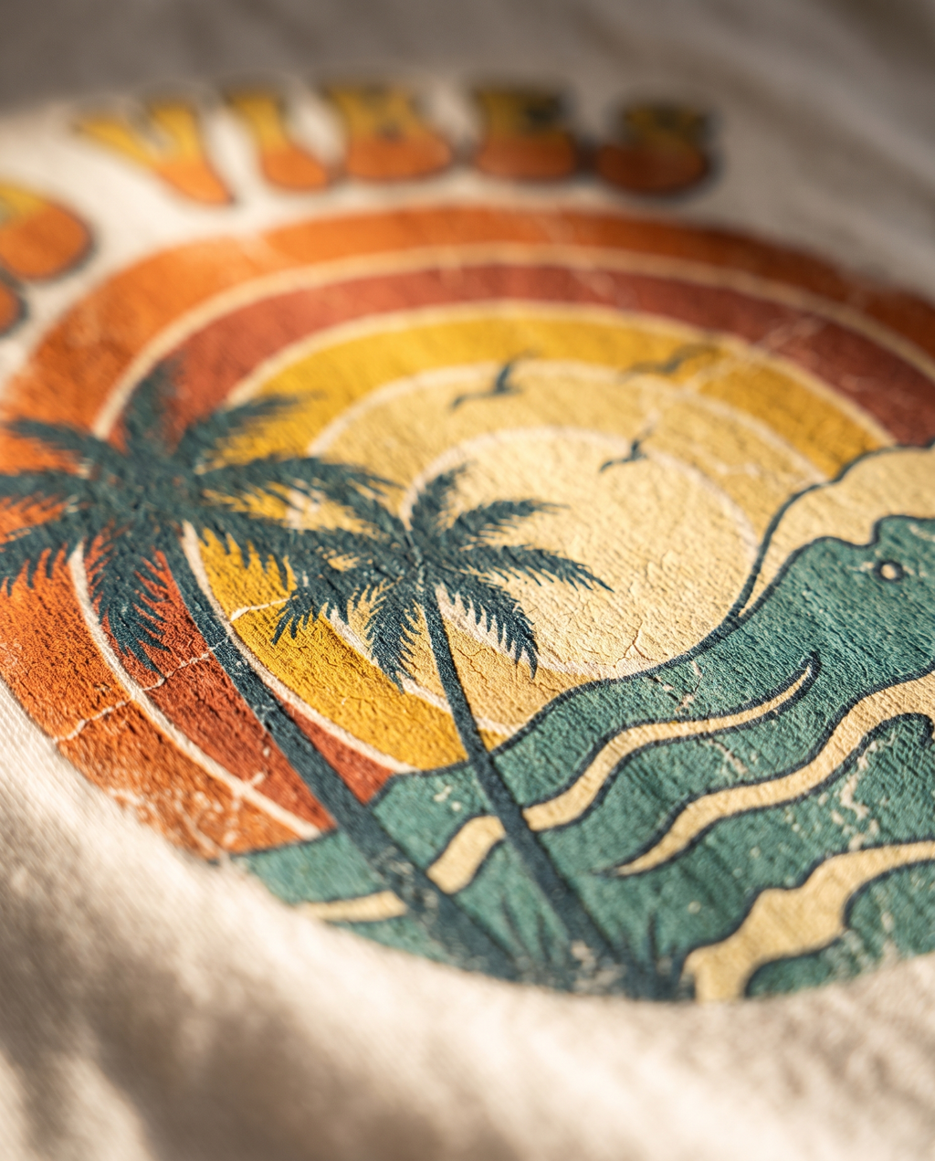 Close-up of the Good Vibes retro sunset screen print on cotton