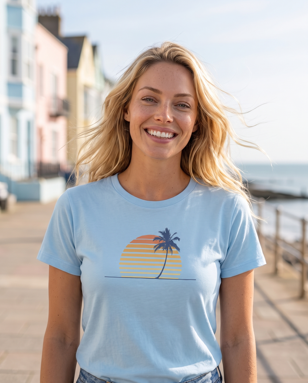 Retro palm and sunset minimalist tee in Carolina blue on a seaside promenade
