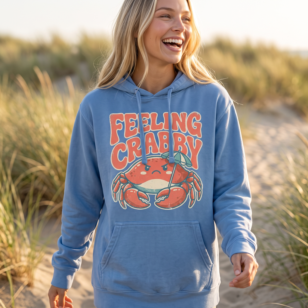 Feeling Crabby hoodie in flo blue, worn by an approved model, close lifestyle photograph on a dune path