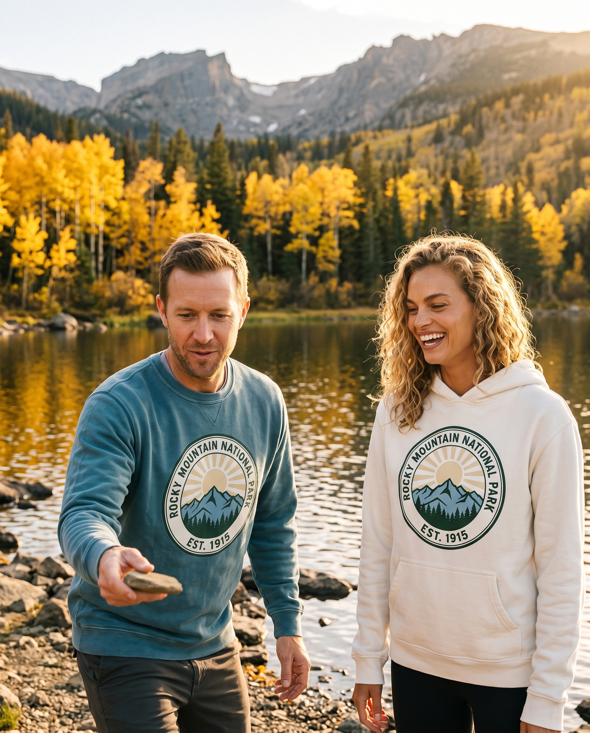 Couple at an alpine lake with golden aspens in a Rocky Mountain National Park crewneck and White hoodie, skipping a stone