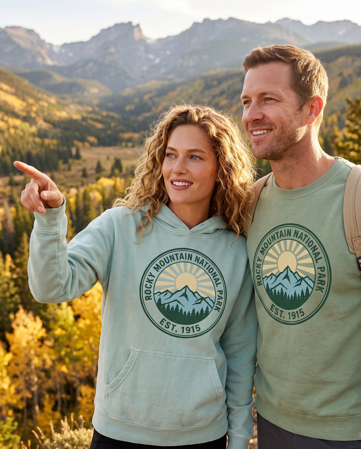 Couple on an autumn mountain overlook in Rocky Mountain National Park EST. 1915 hoodie and crewneck, pointing at the view