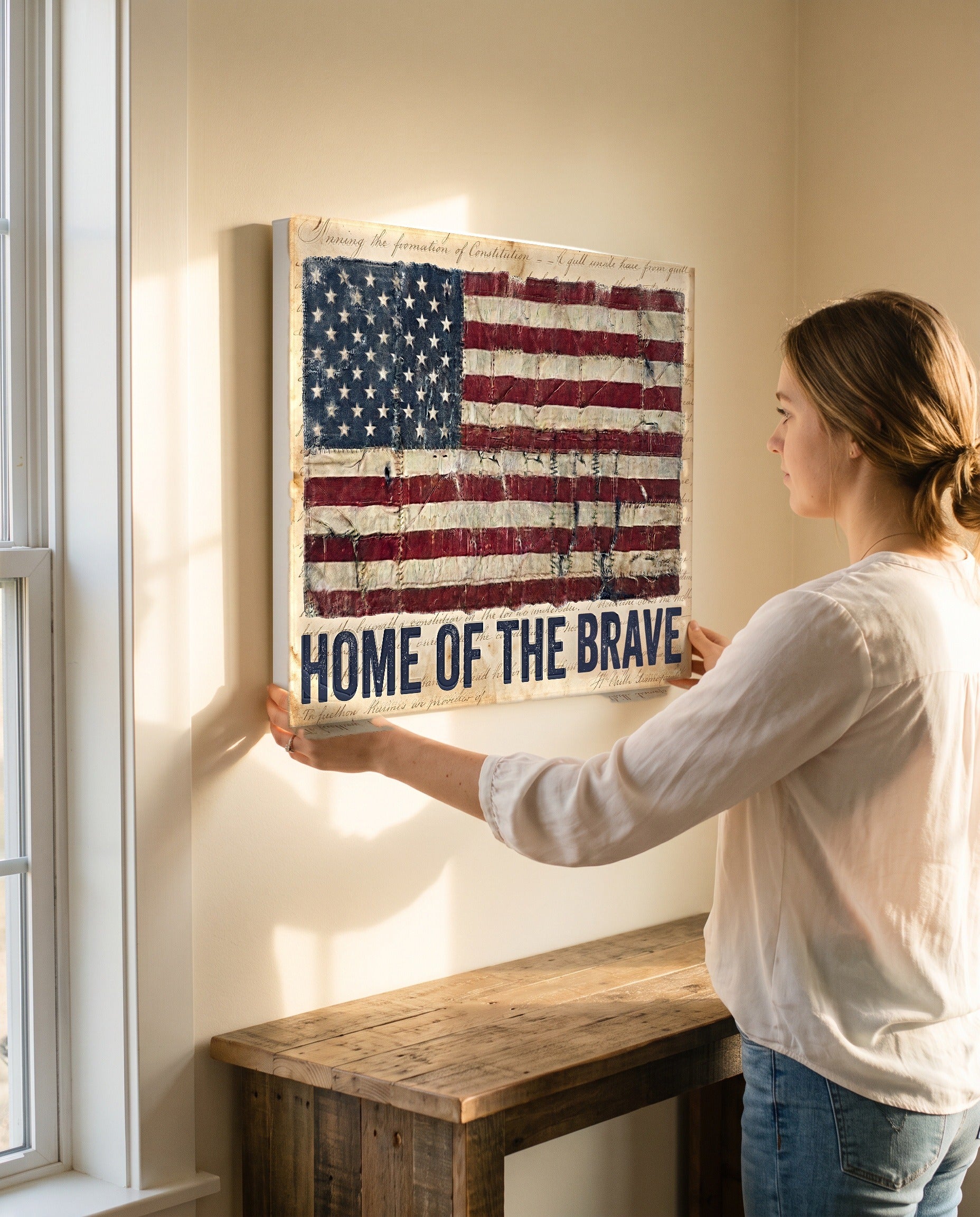 Woman steadying the Home of the Brave flag canvas, showing its true 24 by 18 inch size