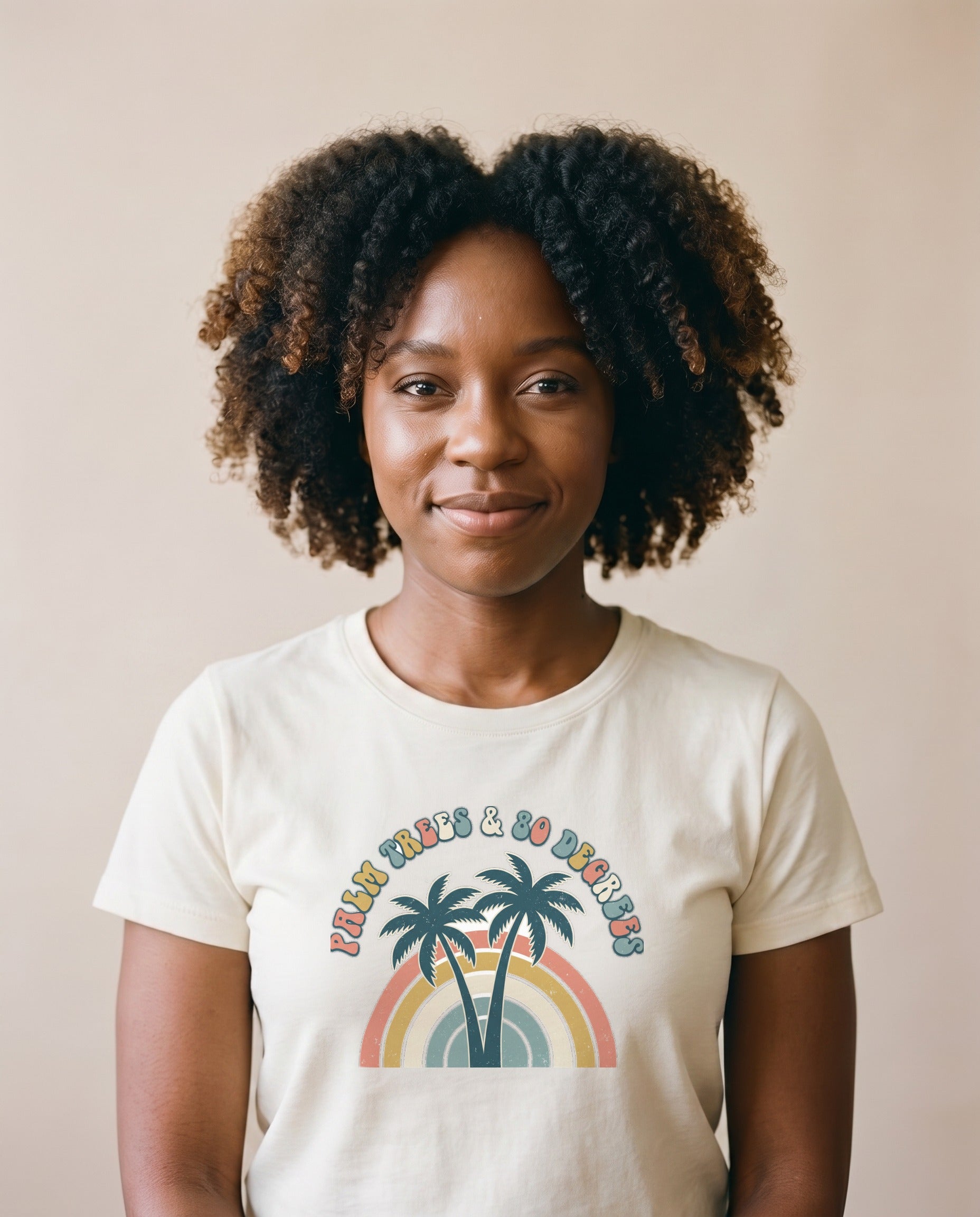 Palm Trees and 80 Degrees retro tee in Ivory on a model, Comfort Colors garment-dyed cream, twin palms and rainbow arch