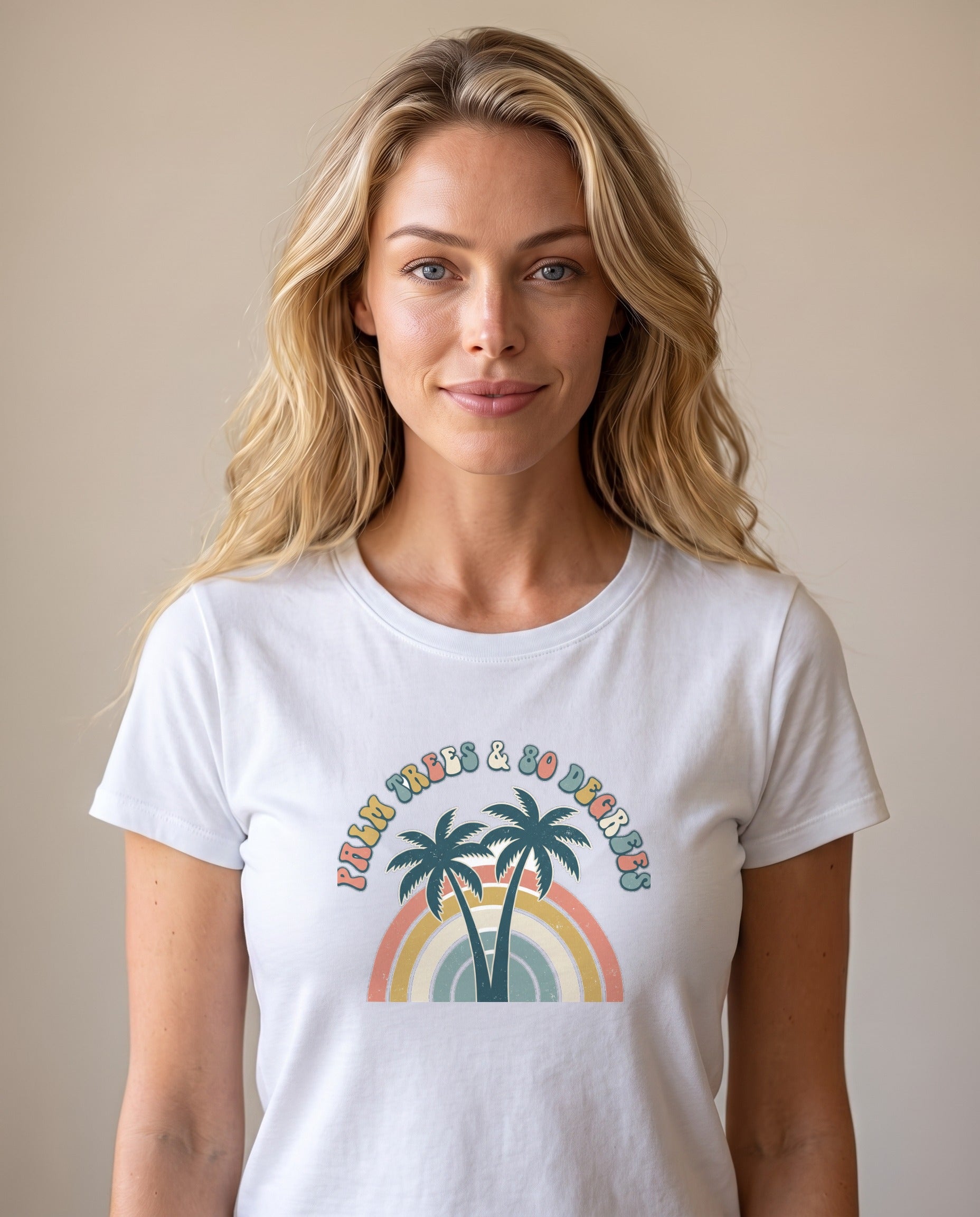 Palm Trees and 80 Degrees retro rainbow tee in White worn by a model, Comfort Colors garment-dyed, twin palms and 70s rainbow arch design