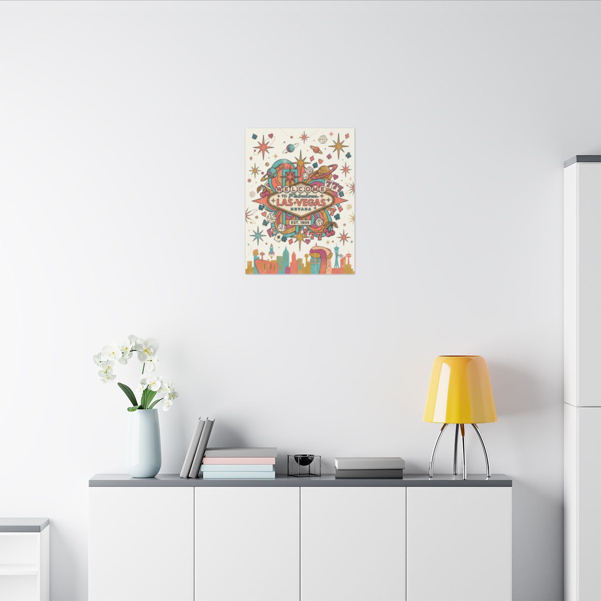 Retro Las Vegas casino canvas on a white wall above a sideboard with a yellow lamp and orchids