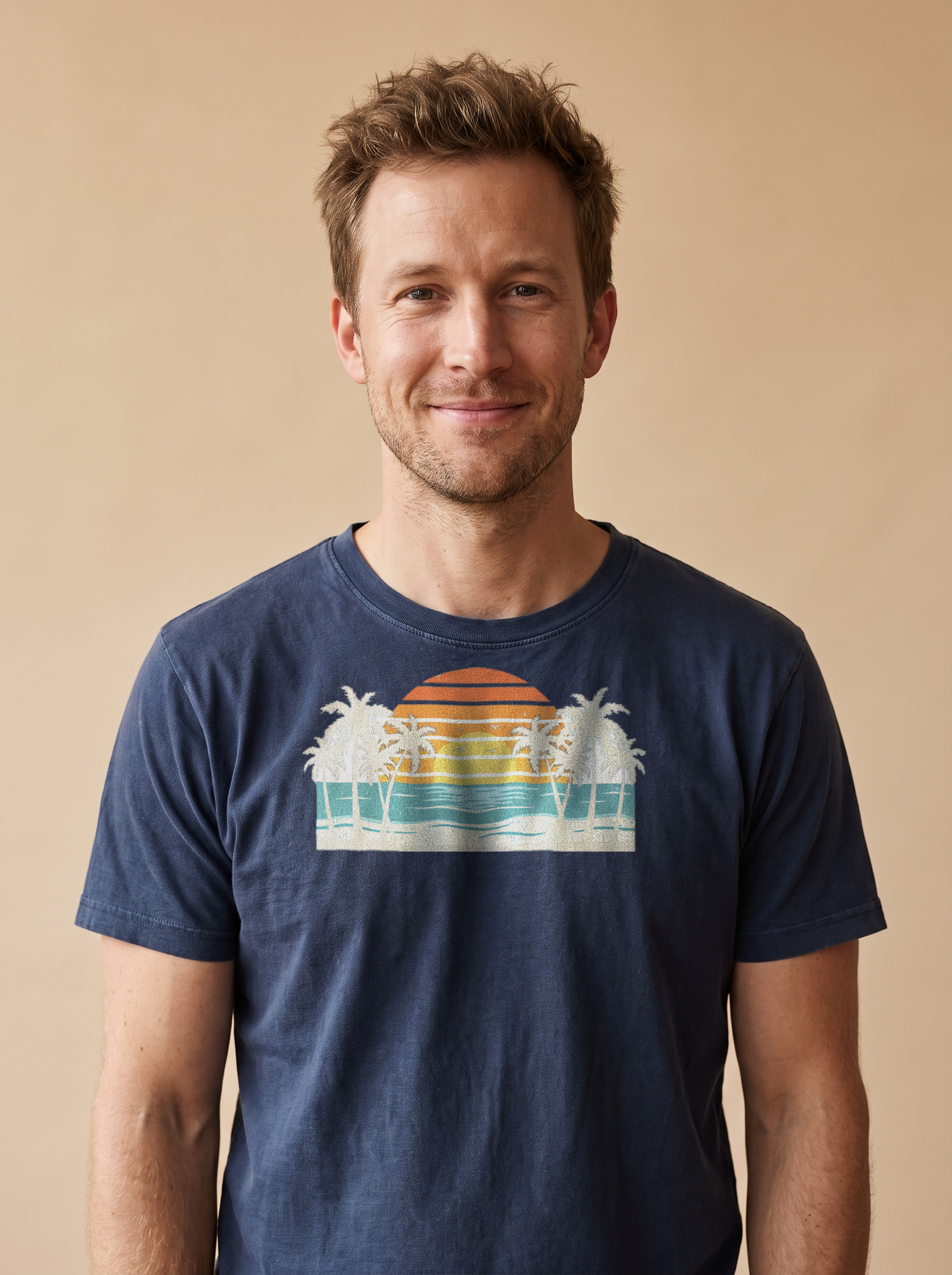 Man wearing the Retro Beach Sunset tee in True Navy, cream single sun with palms and waves centered on the chest