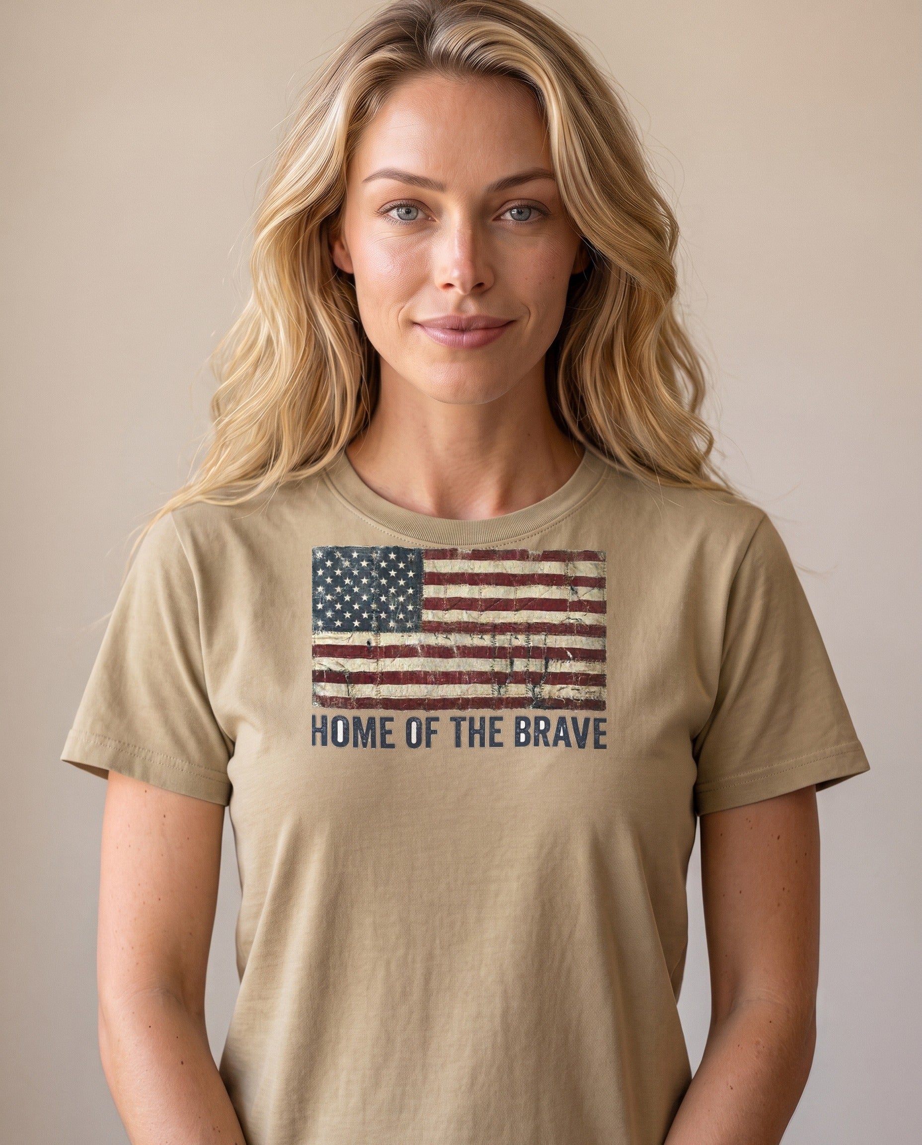 Woman wearing the Home of the Brave tattered flag tee in Khaki, distressed vintage American flag print, natural light portrait