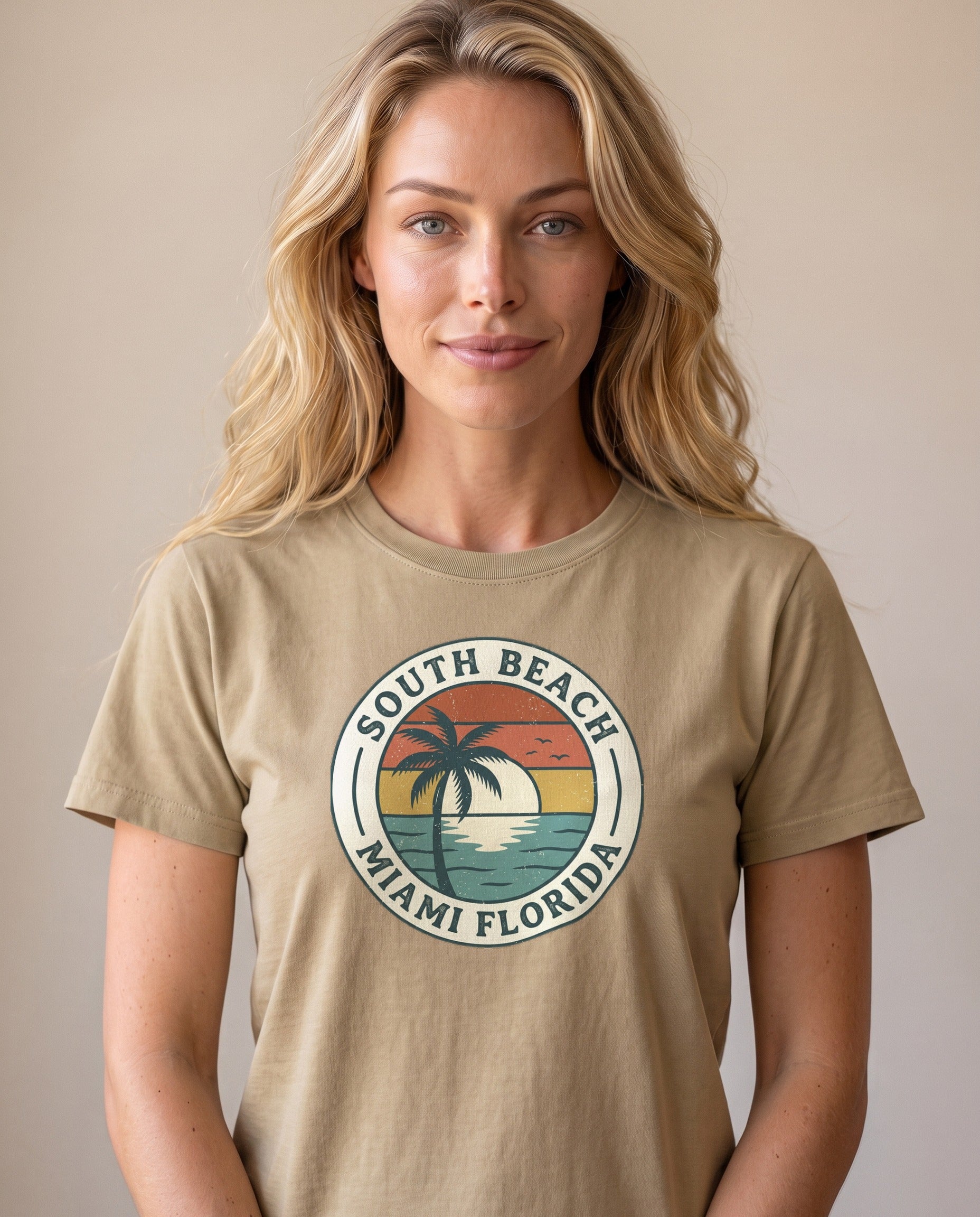 Woman wearing the South Beach Miami Florida retro badge tee in Khaki, vintage travel badge with palm and sunset